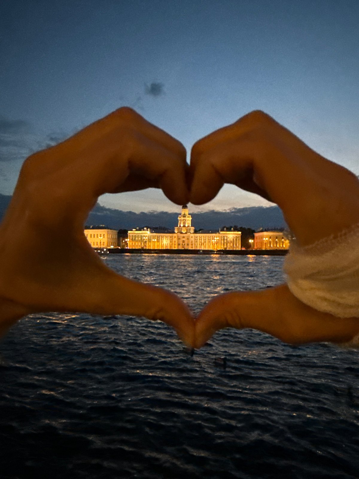 Evening gatherings along Saint Petersburg's illuminated Neva River embankment