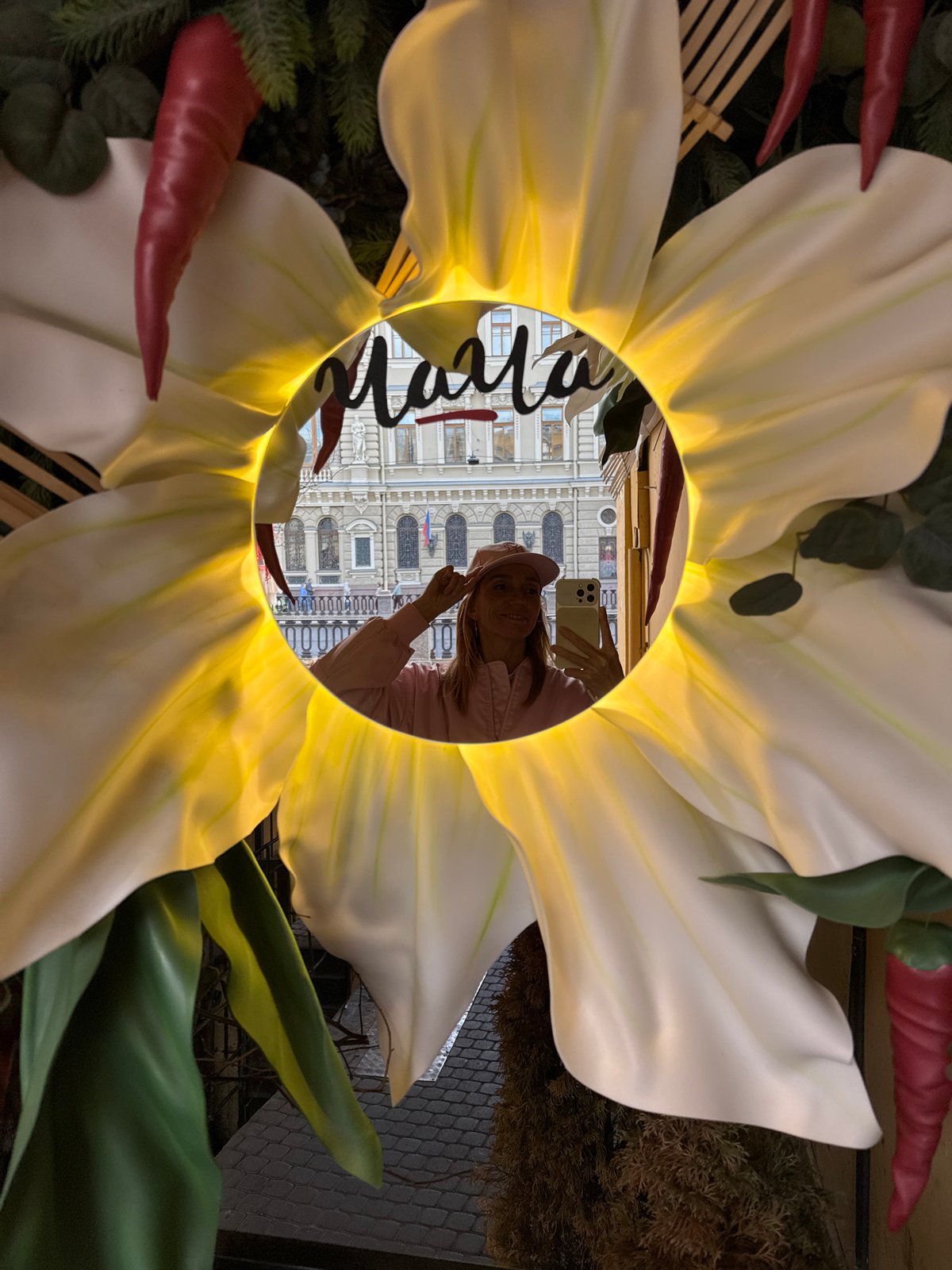 Tourist captures selfies and street scenes near historic Saint Petersburg church