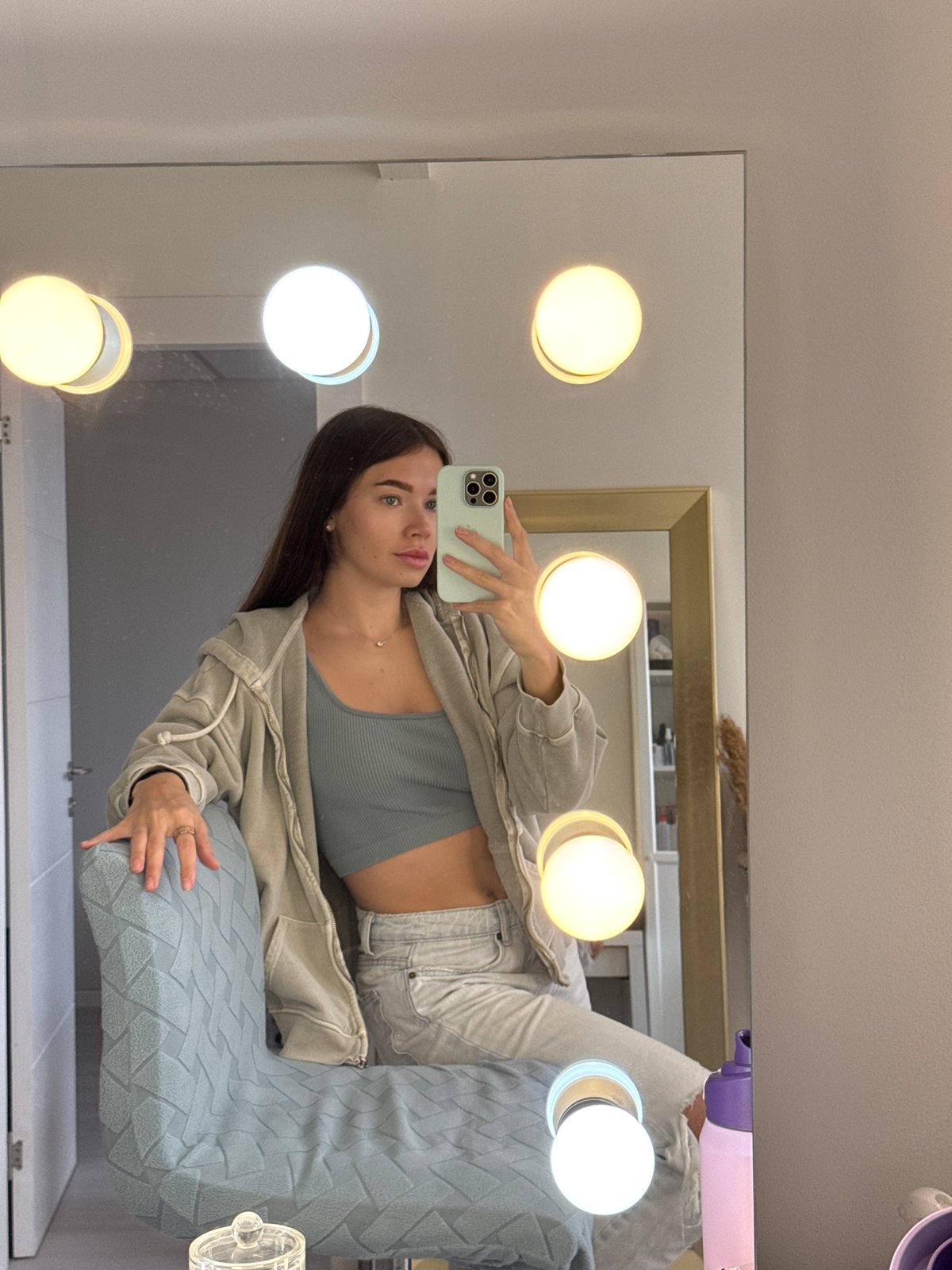 Woman takes mirror selfie in Ramat Gan bathroom