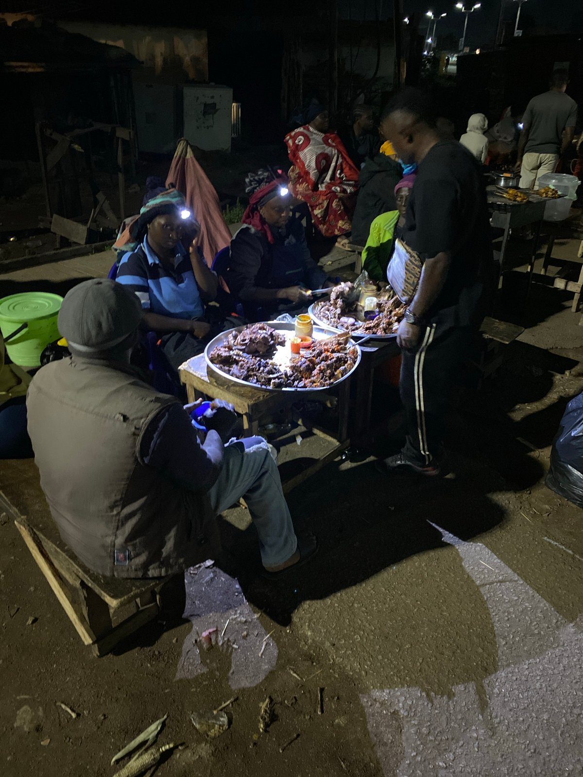 Night street food vendor serves customers in Bukuru, Nigeria
