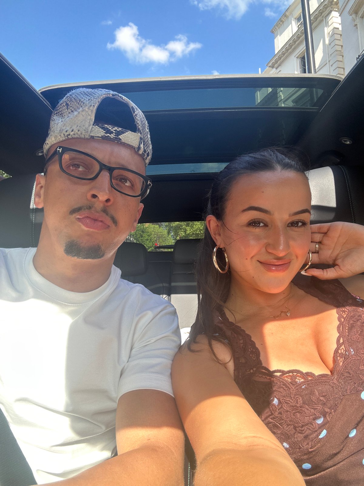 Couple enjoys sunny afternoon drive in London convertible