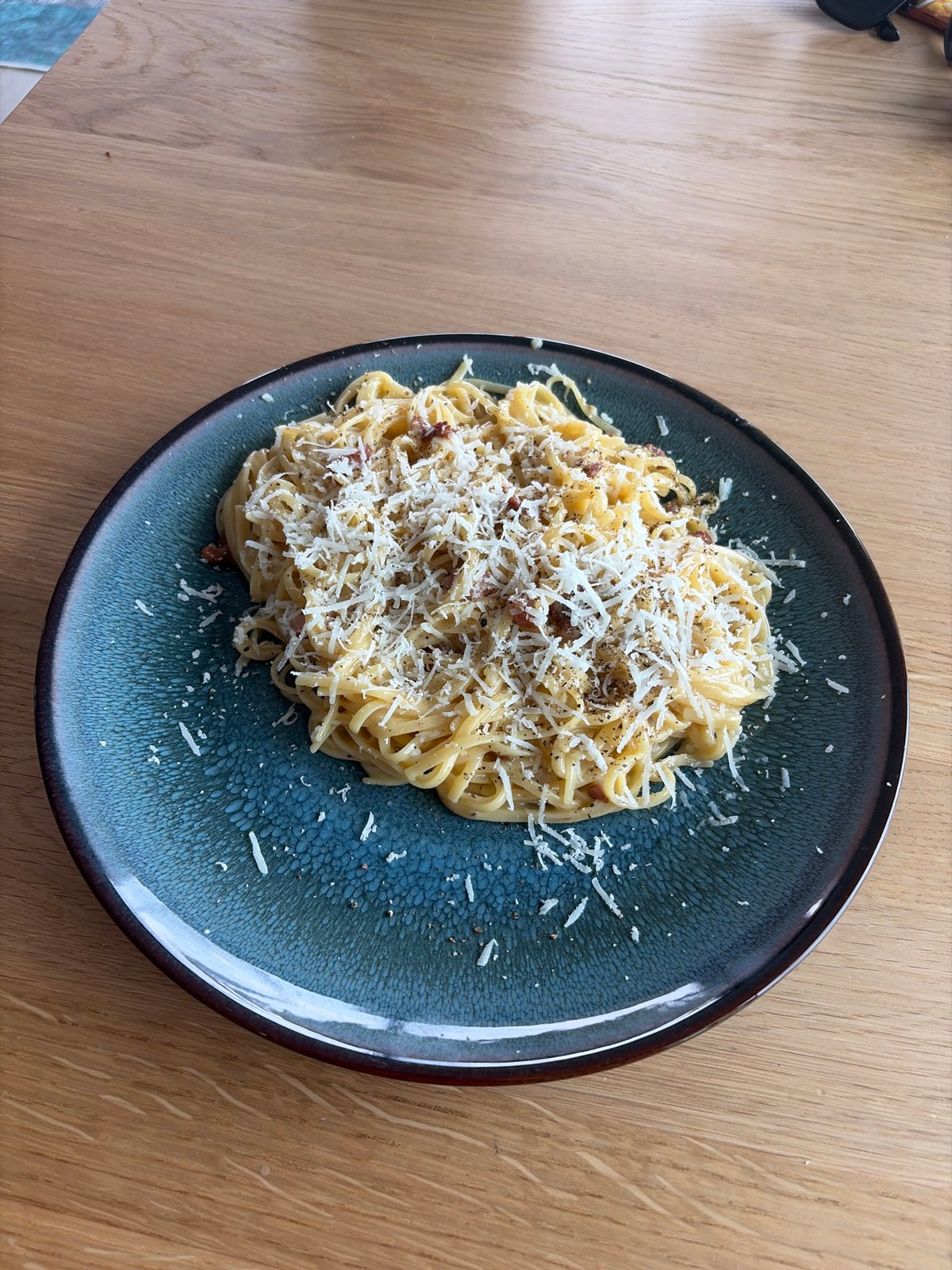 Spaghetti carbonara up close on a wooden table in Rijswijk