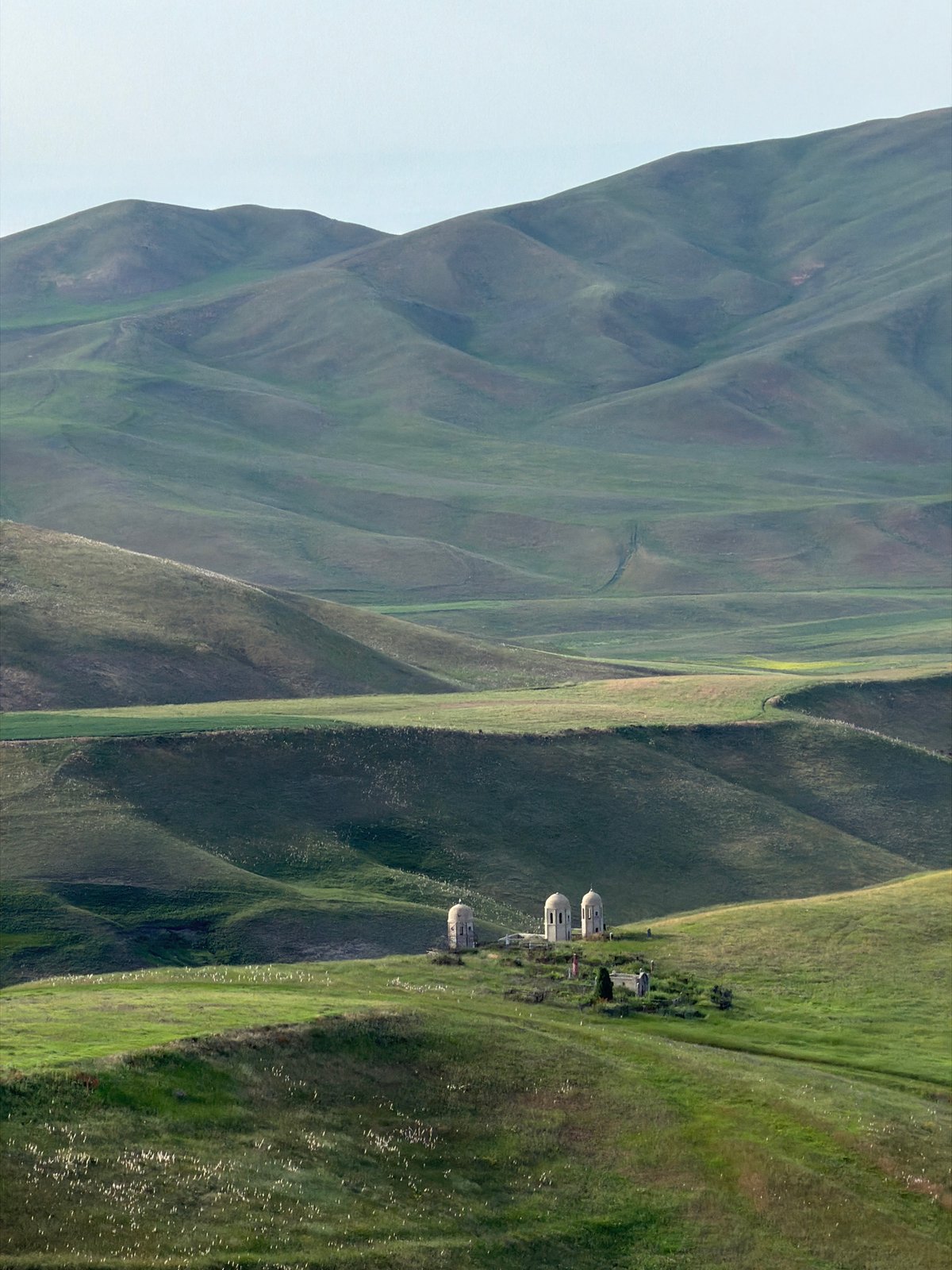 Rolling hills and farmland of Toguz-Bulak, Kyrgyzstan in summer