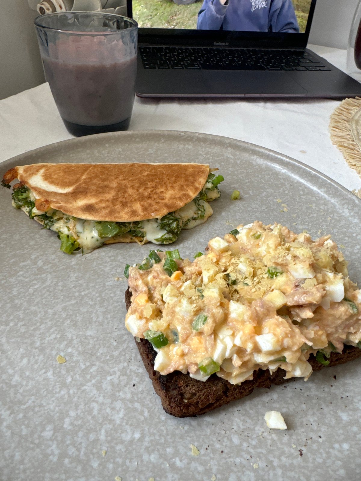 Breakfast meal photographed in Krasnoyarsk includes sandwich, quesadilla, smoothie