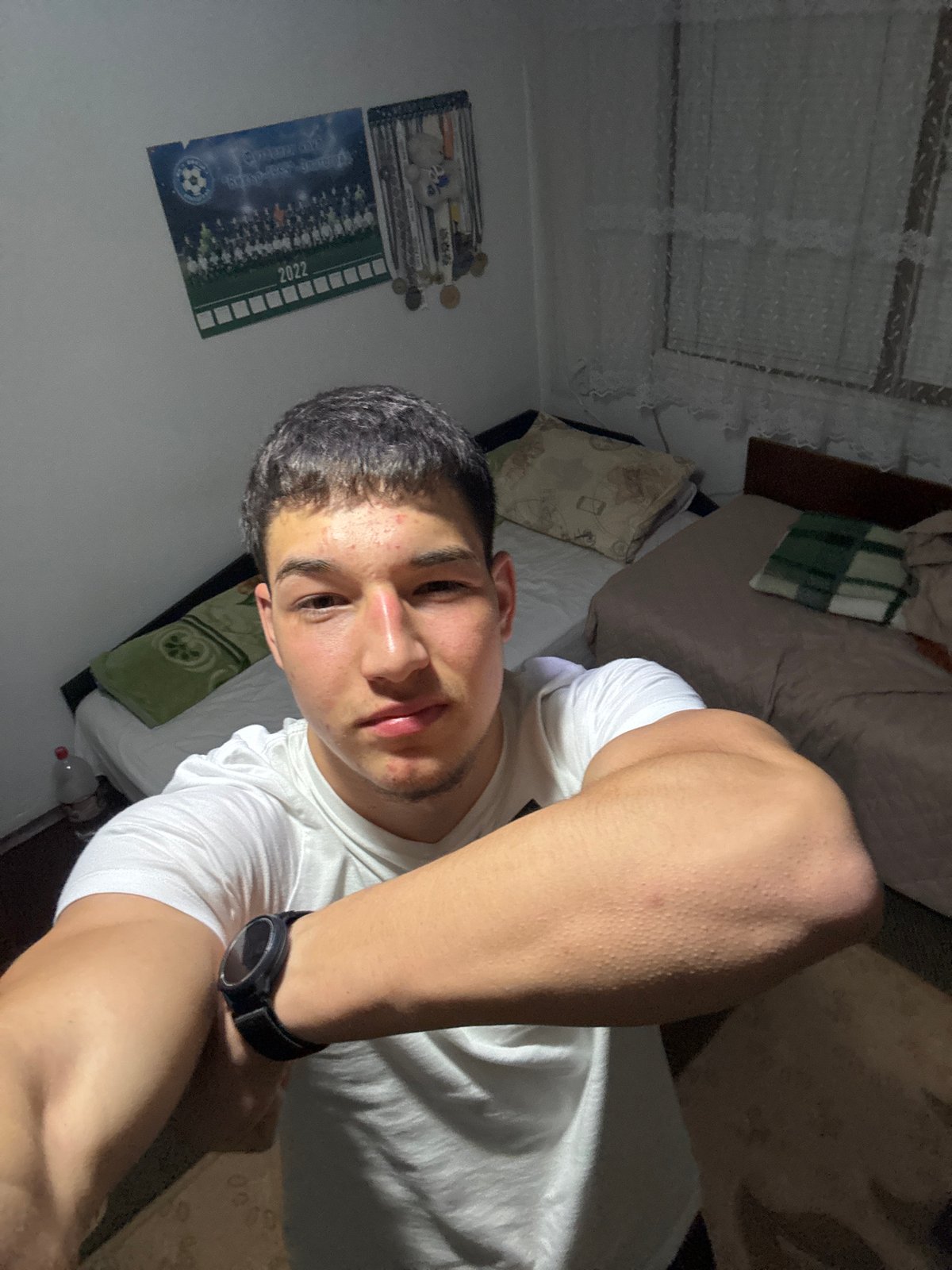 Young man takes selfies in bedroom in Zlatograd