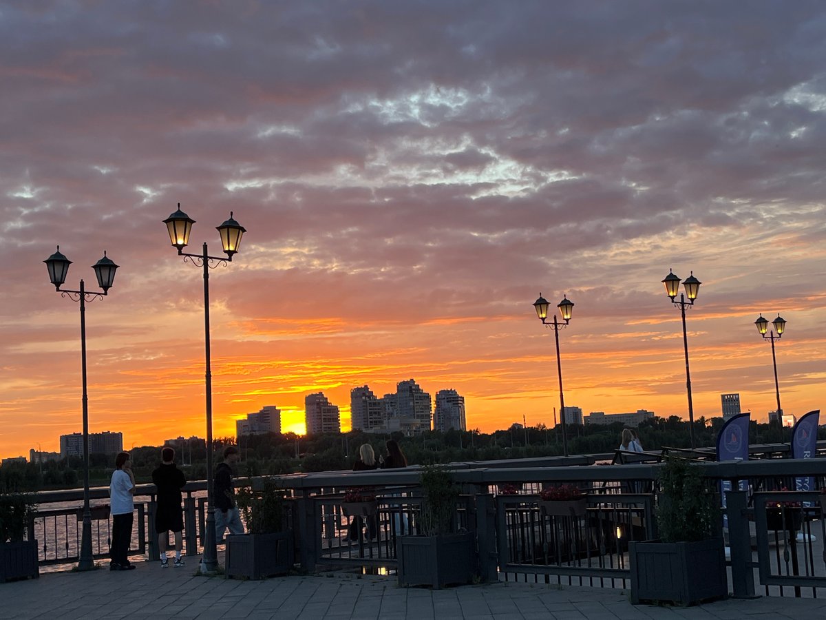 Sunset evening along Kazan's riverfront with rides and city views