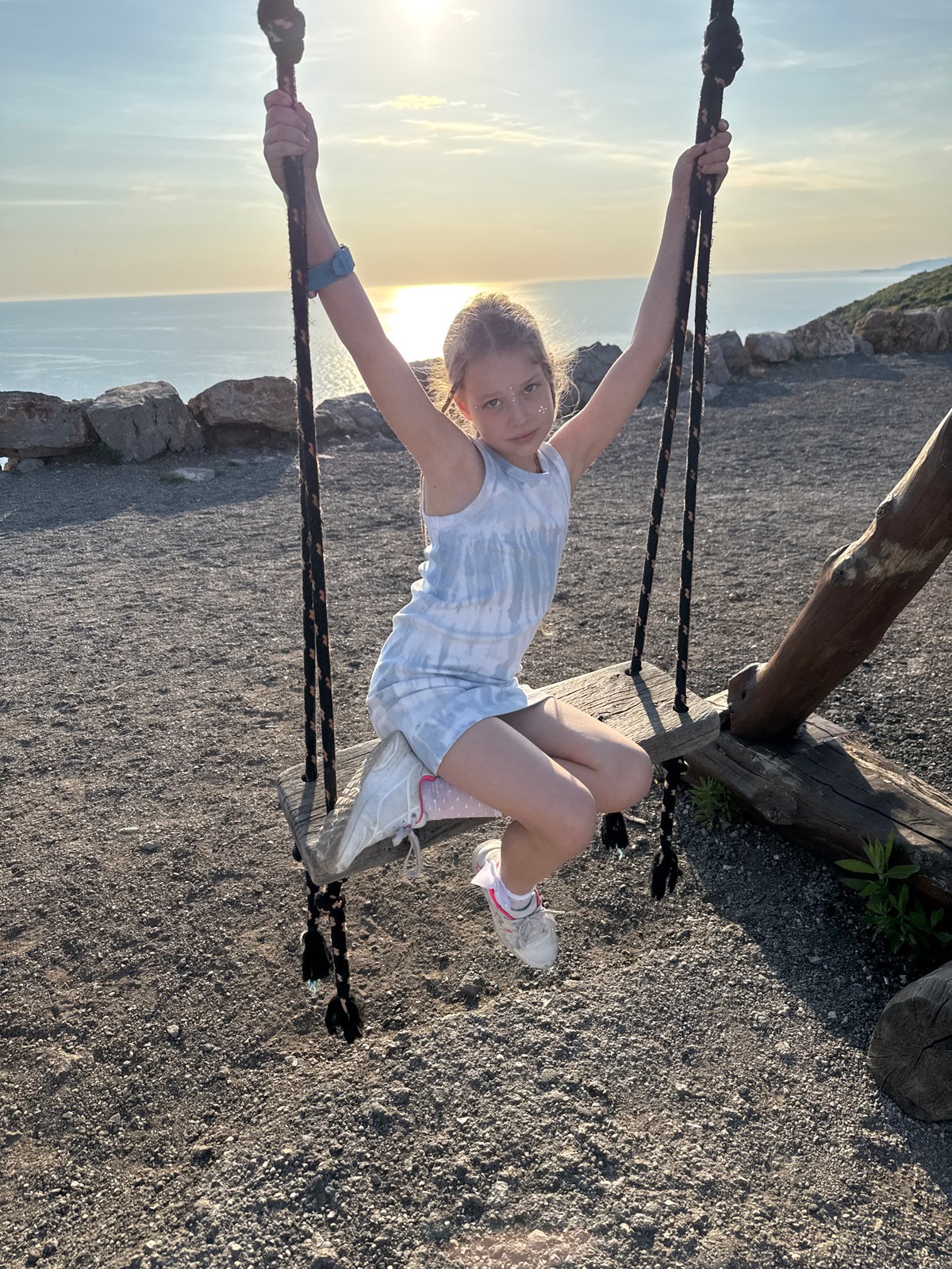 Child swings at sunset in Montenegro countryside