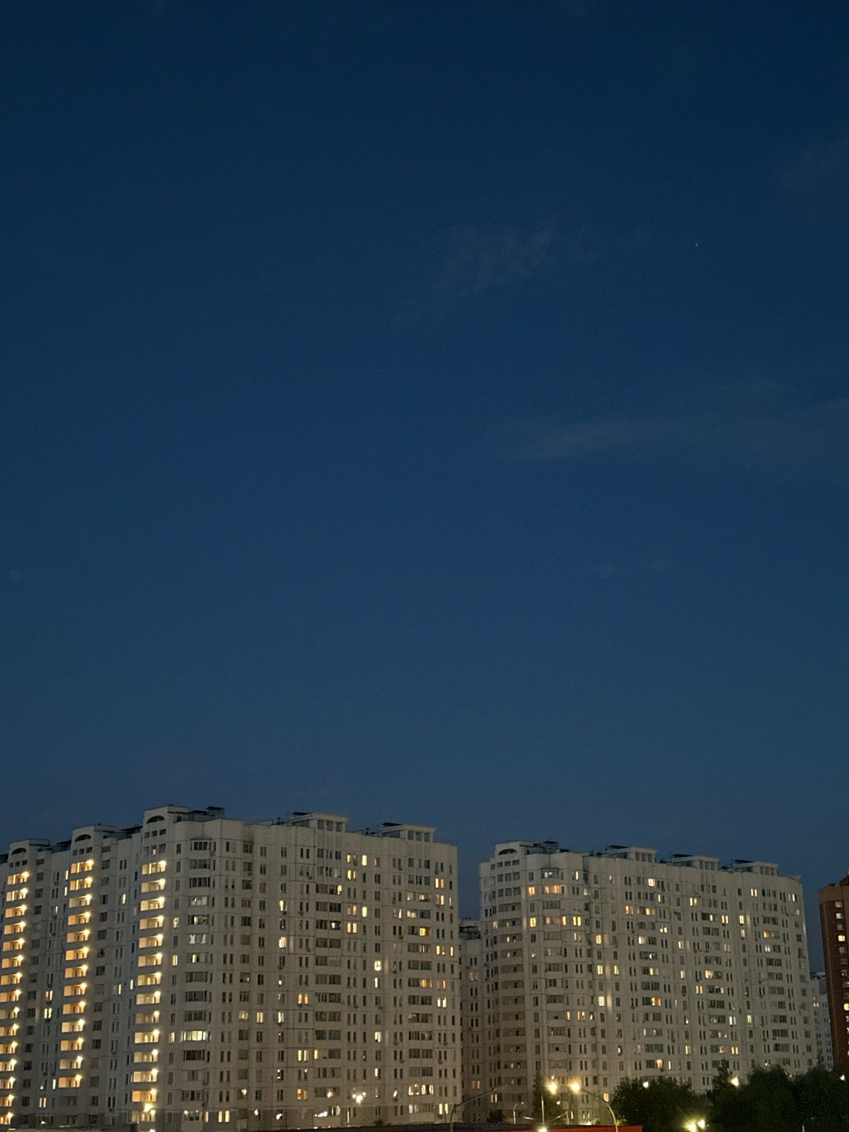 Podolsk residential towers lit up at dusk