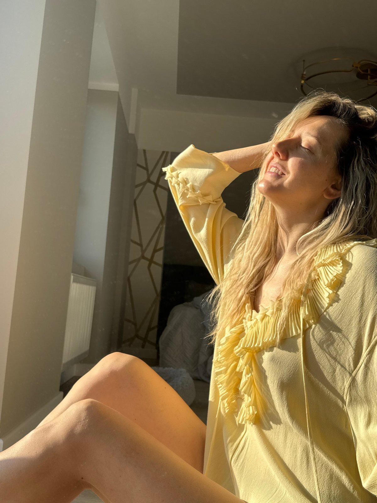 Woman takes morning selfies in Carnikava home studio setup