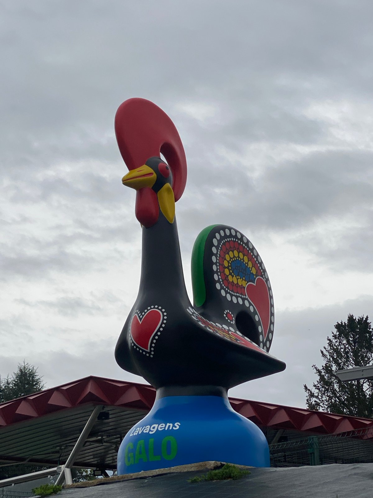 Tourists document famous Barcelos rooster statue in Portugal