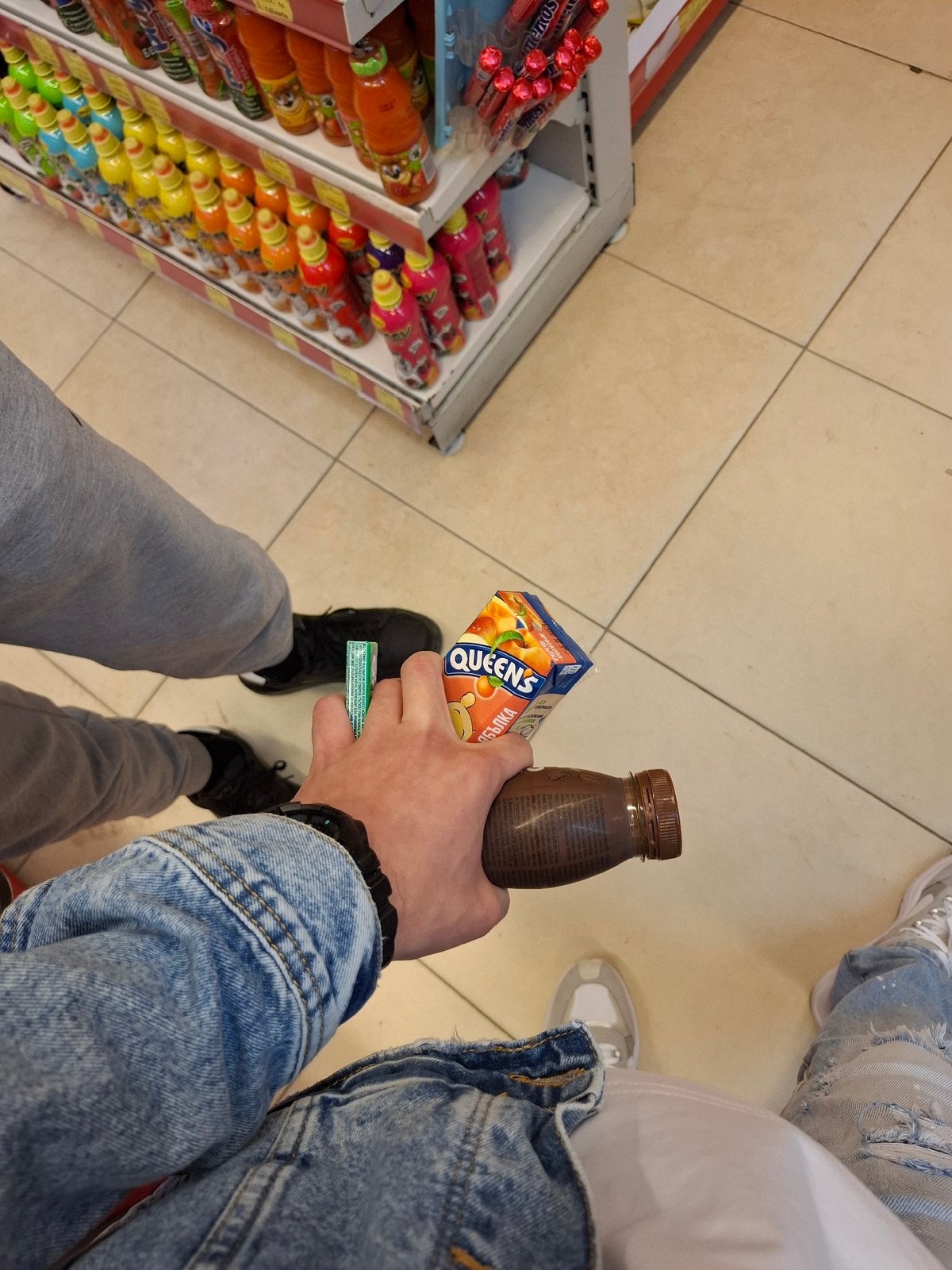 Shopper selects beverages at Veliki Preslav store