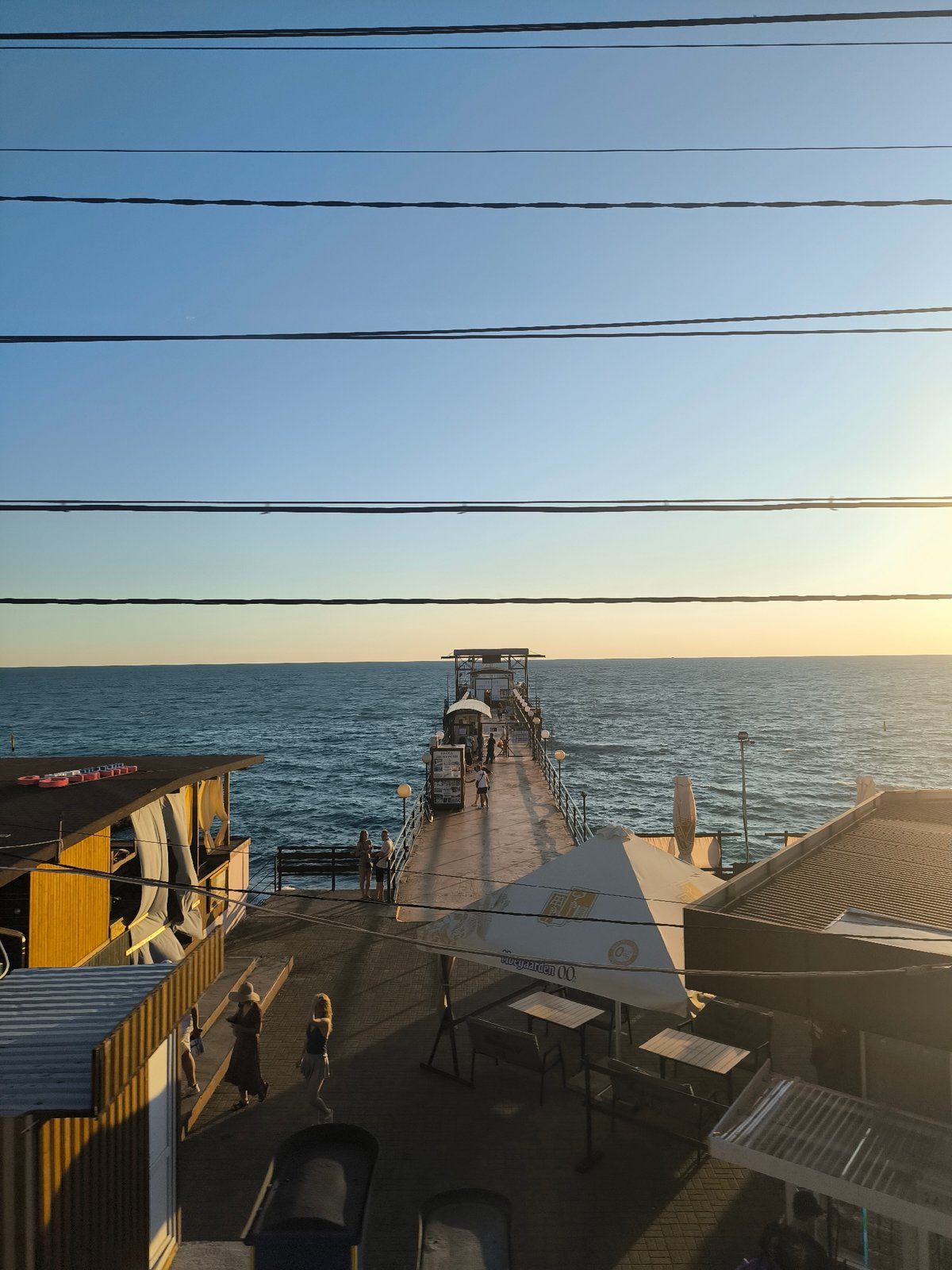Coastal city exploration by train, pier, and beach deck