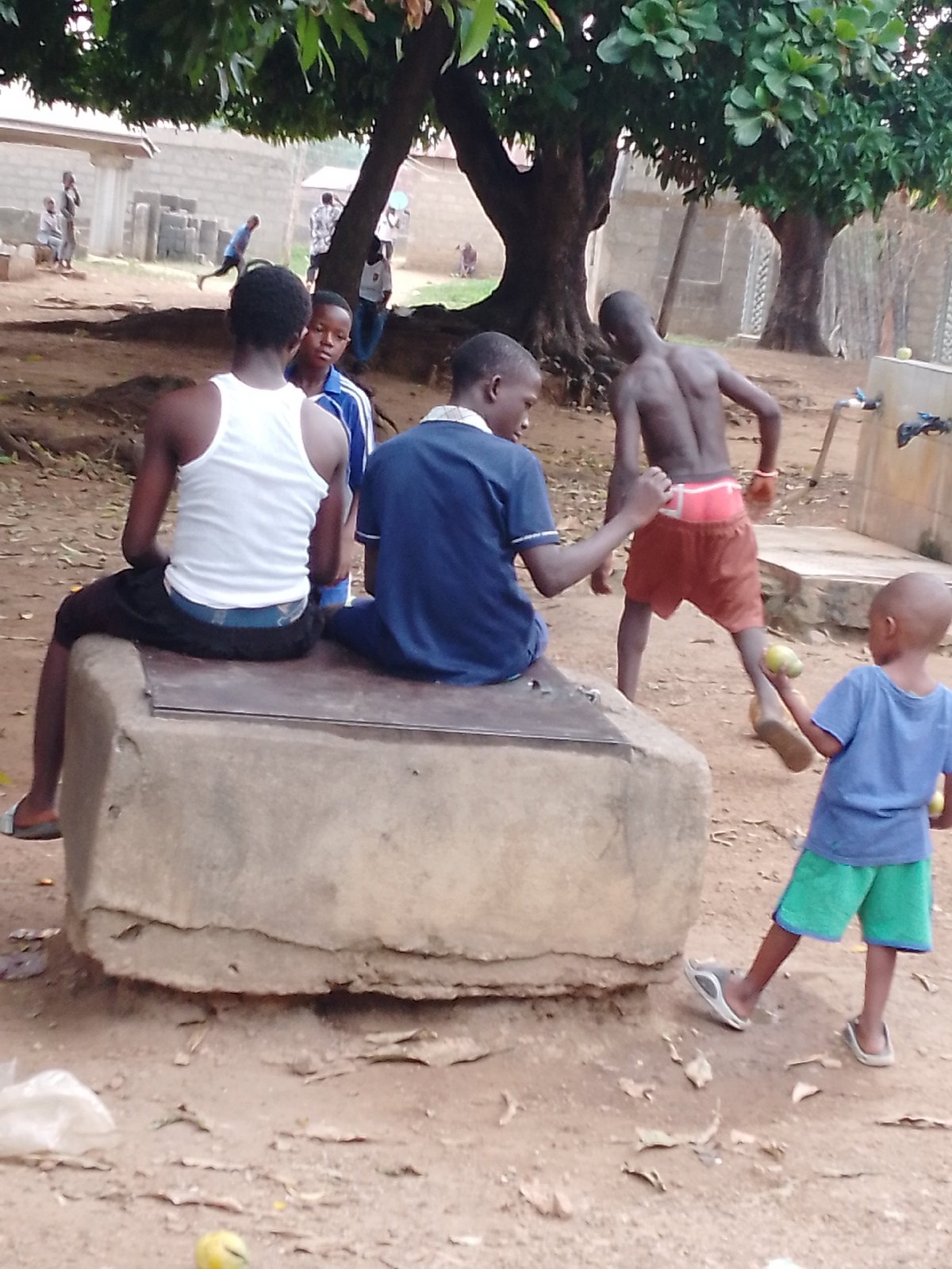 Rural village gathering captures men and boys outdoors