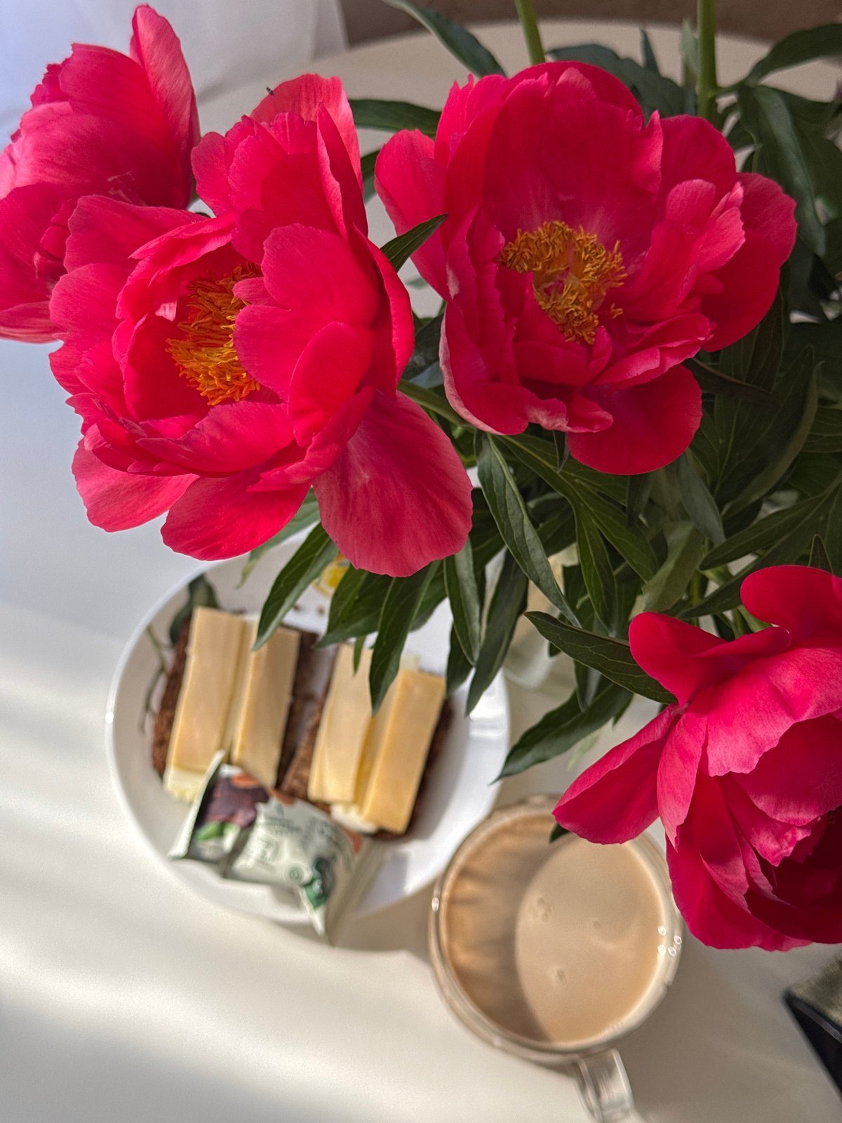 Morning moments documented across Chaikovsky, Russia include flowers, coffee, selfie