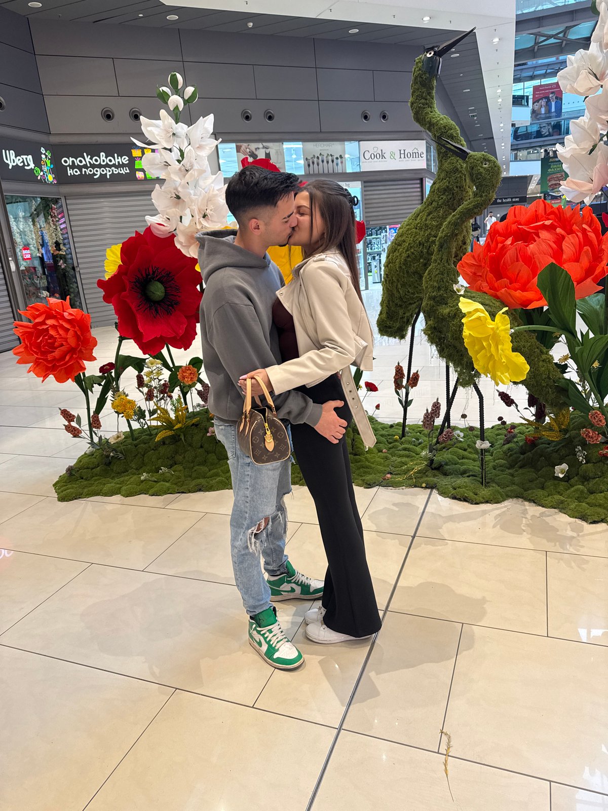 Couple shares kiss at Sofia mall flower display
