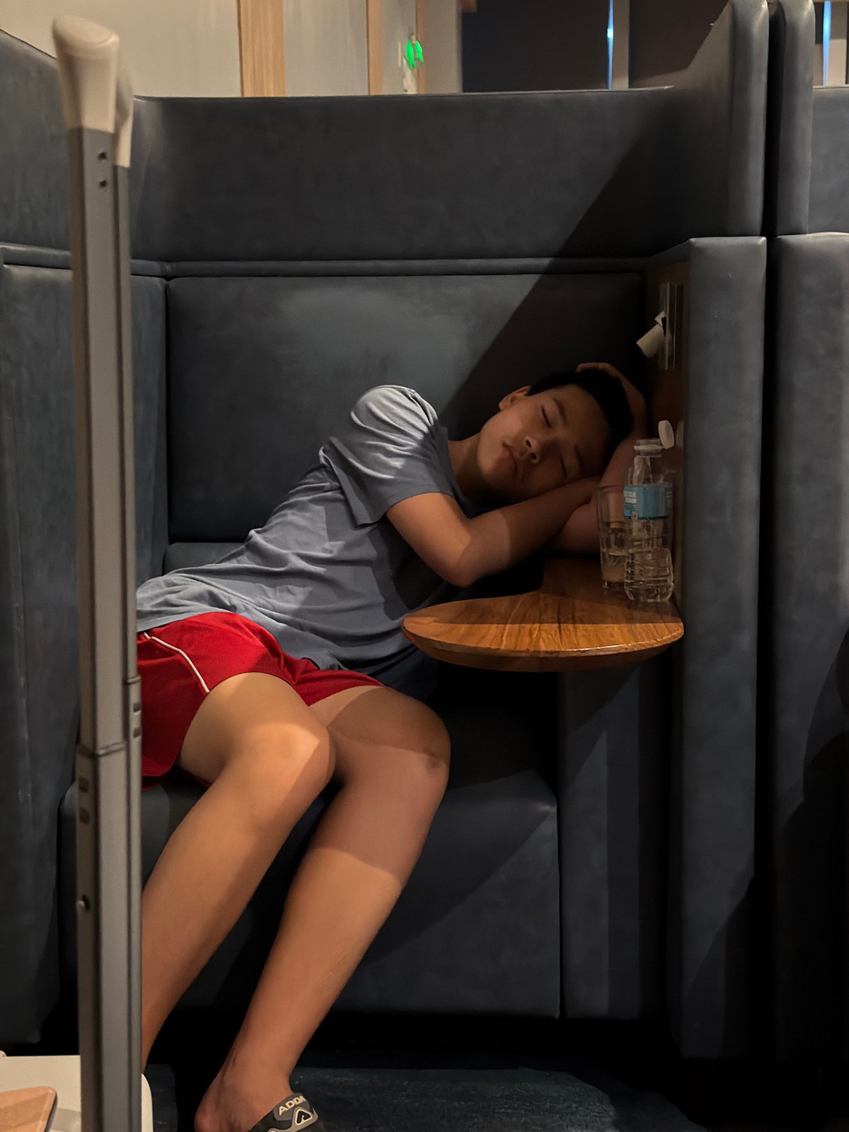 Young traveler sleeps on bench in Lapu-Lapu commercial area