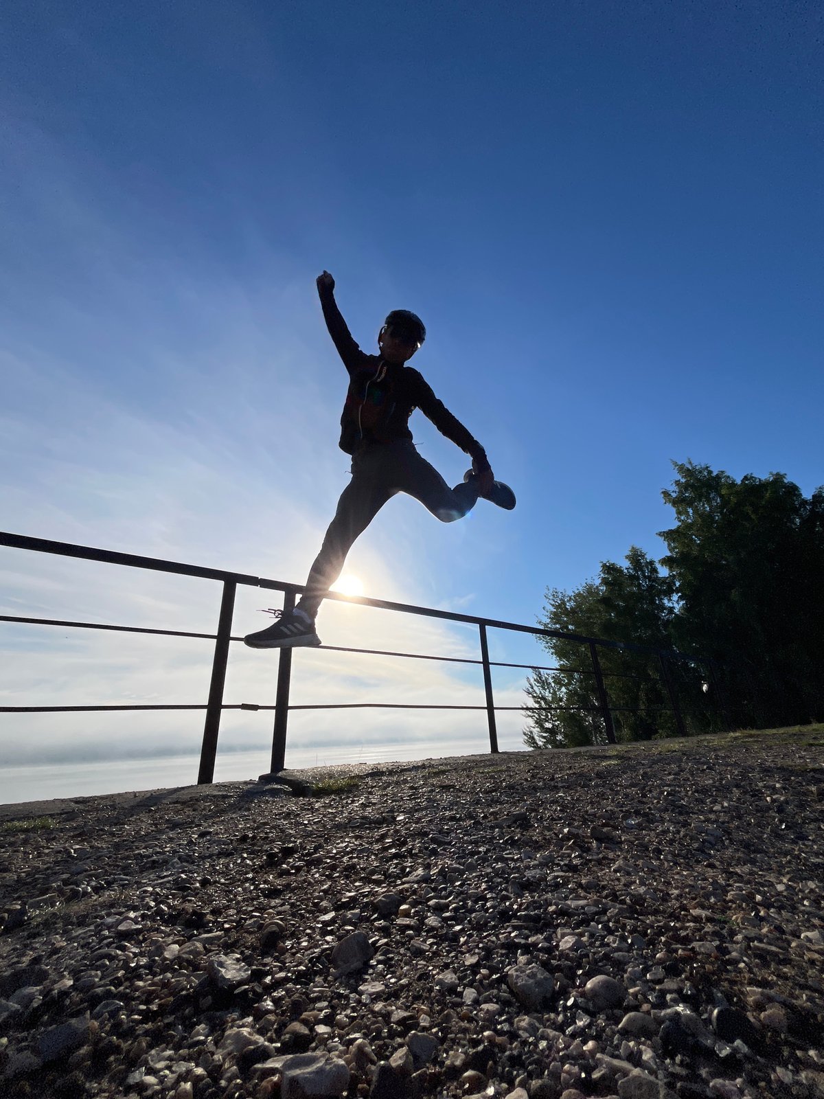Cyclist stops to play along the Kama River at sunrise