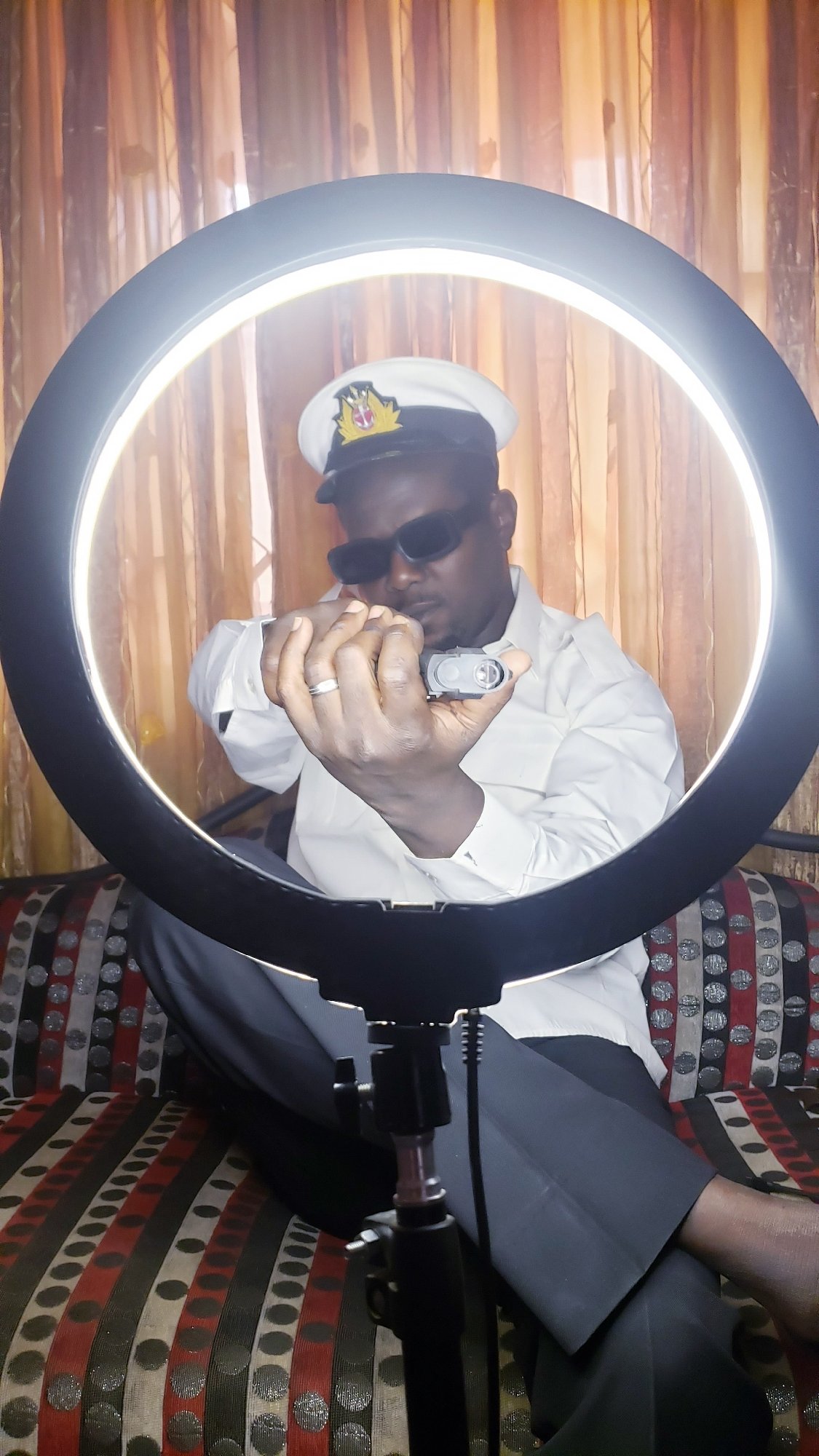 Man poses for ring light photo session in Nigeria