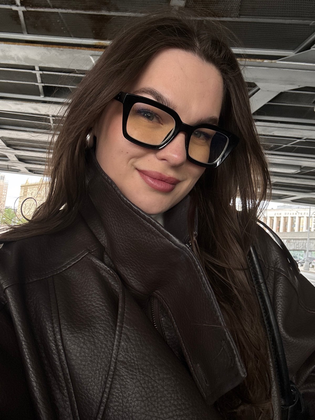 Woman photographed near white steel building in Moscow