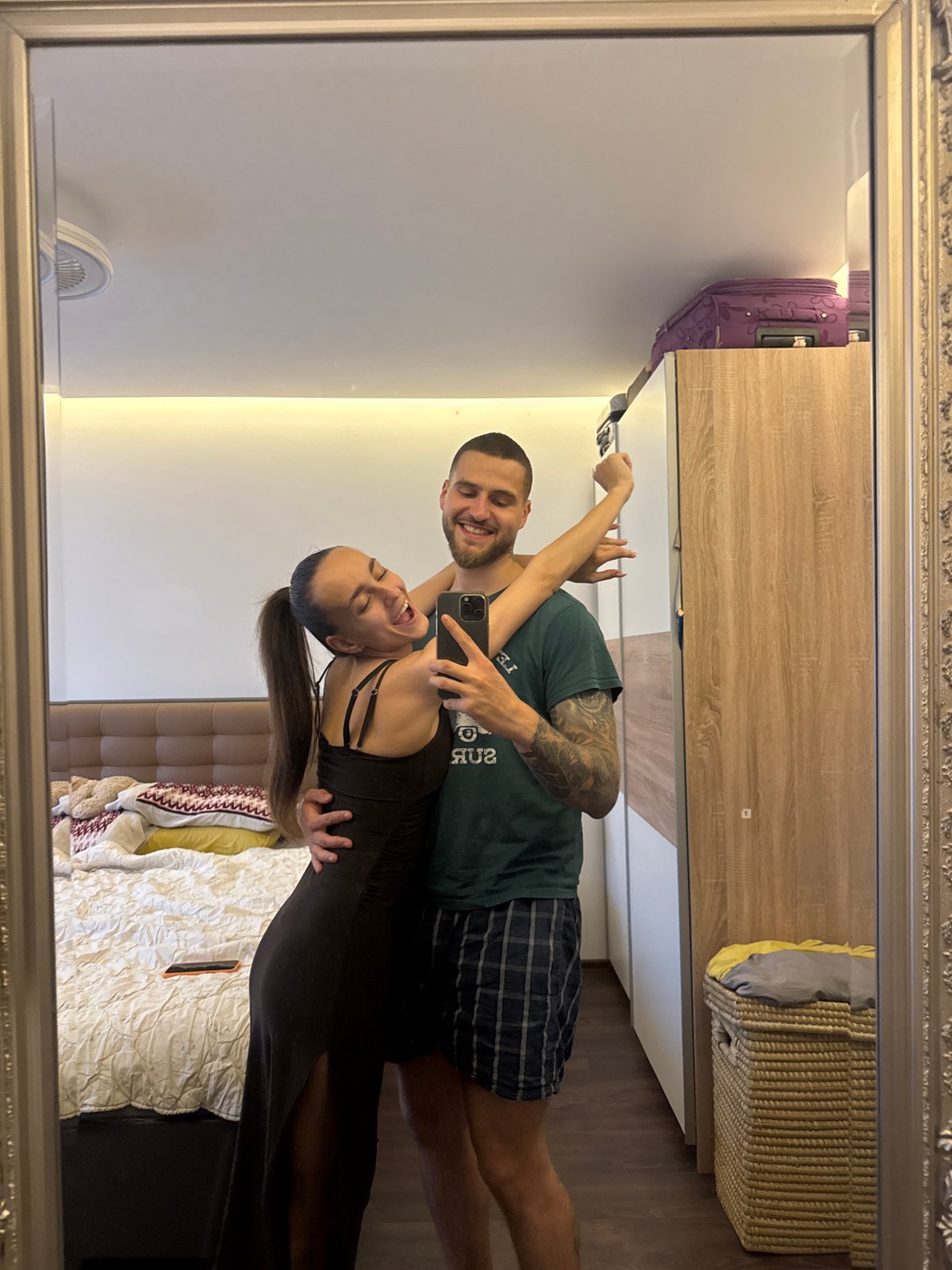 Couple takes mirror selfies in Sofia bedroom