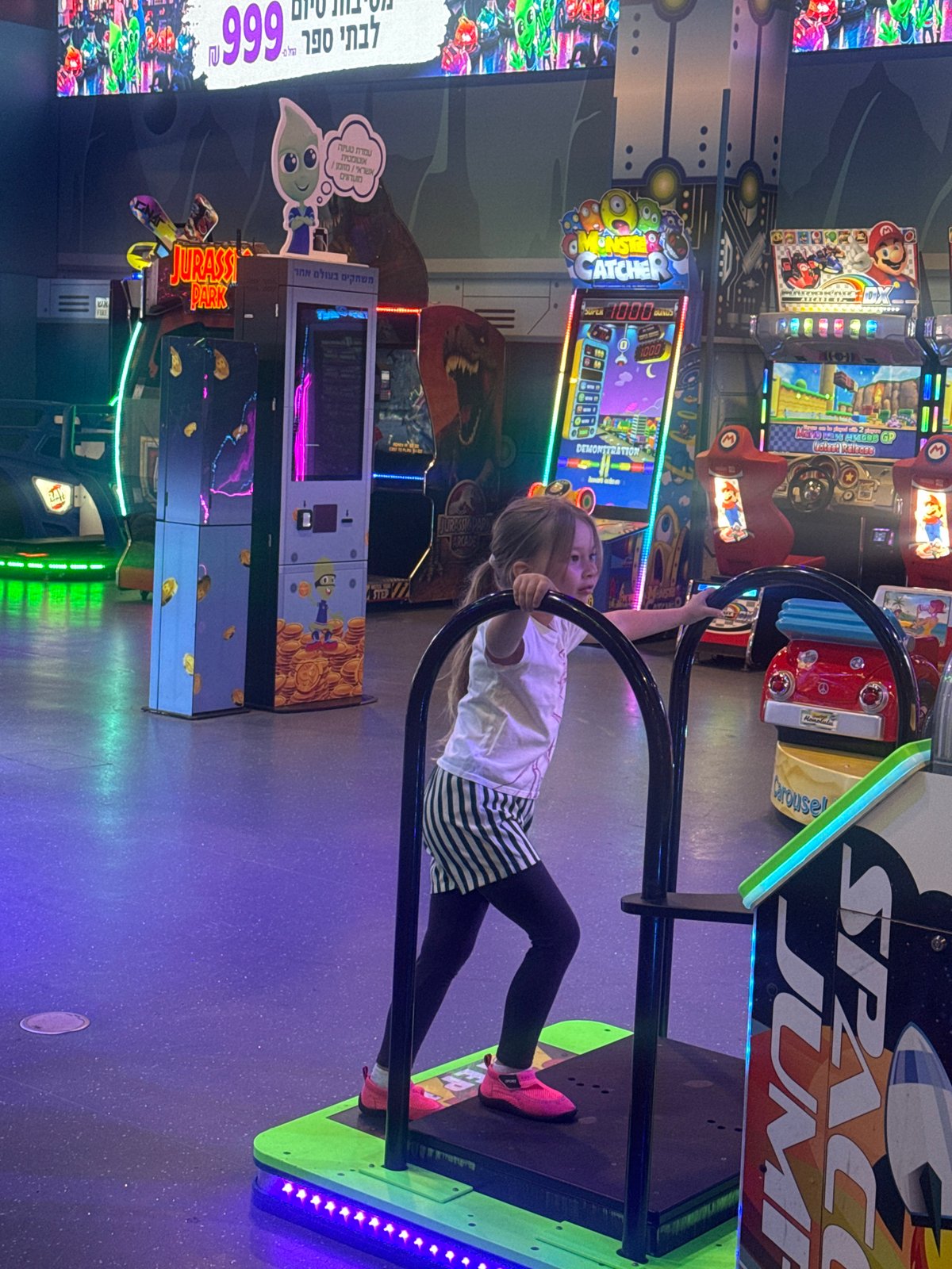 Child plays arcade games at Tel-Aviv gaming center