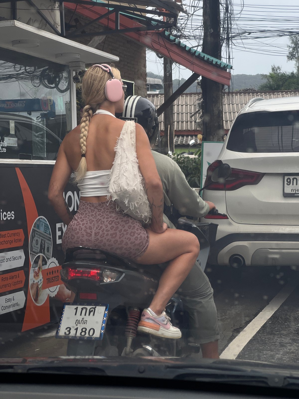 Street scene photographed from vehicle in Southeast Asian city