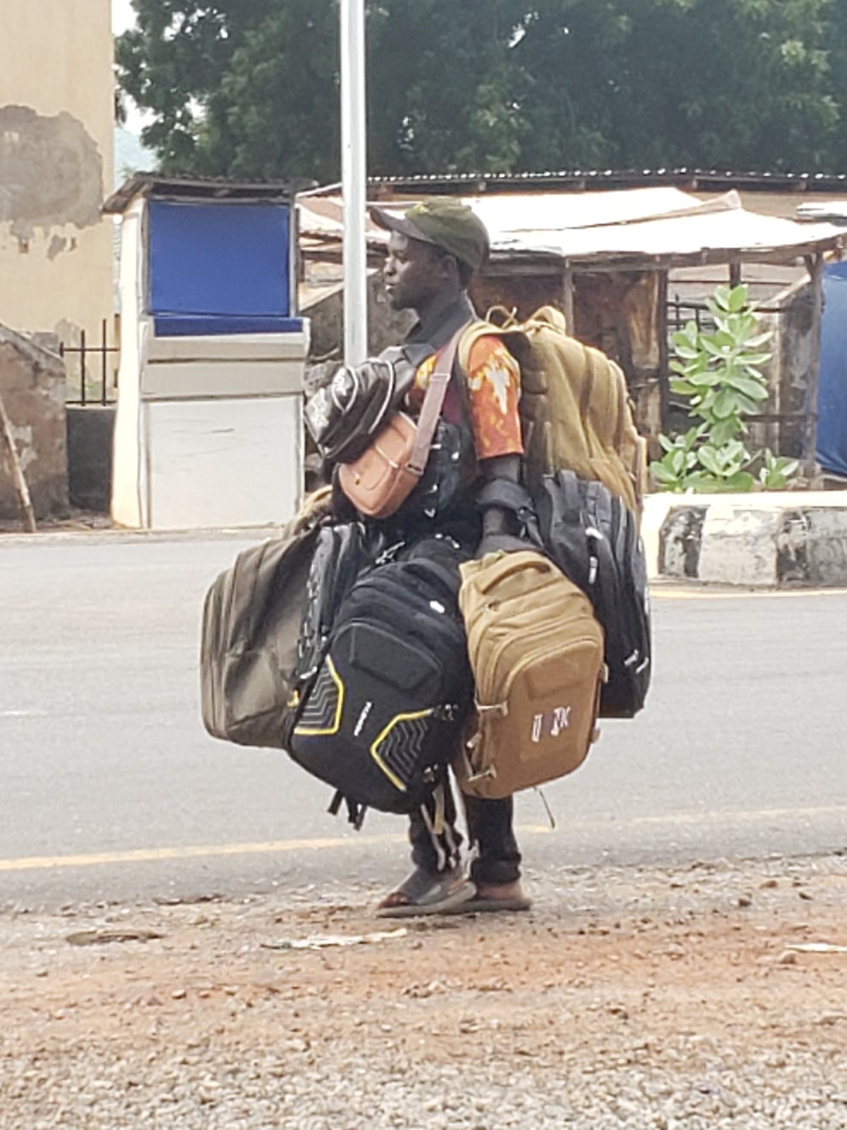 Daily life unfolds on Adankolo road amid cloudy afternoon