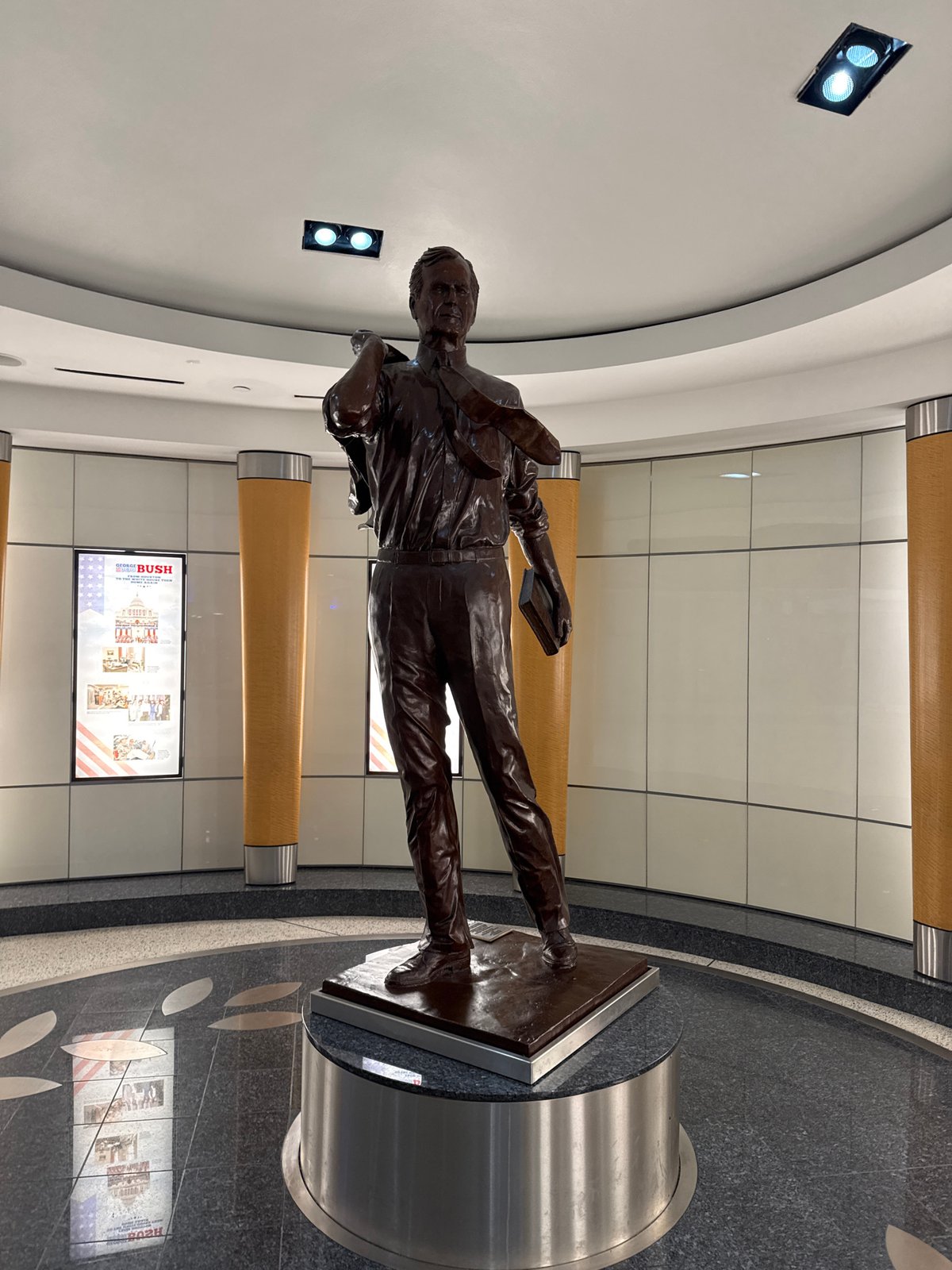 Bronze statue of suited man with book observed in Houston interior