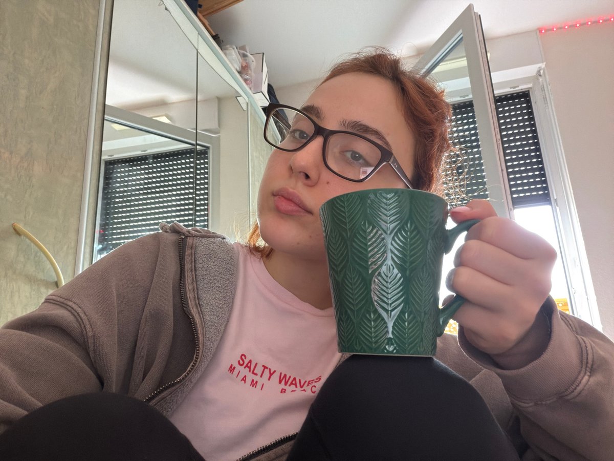 Woman takes selfies with laptop and phone in Strasbourg