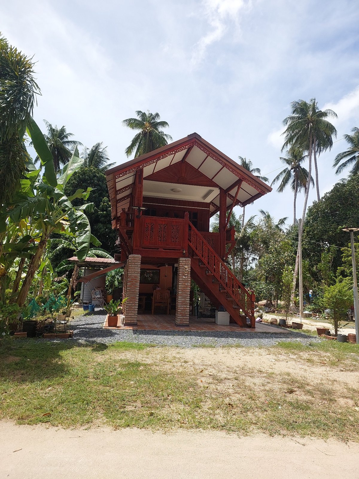 Traditional stilt houses and coconut piles in rural Koh Samui