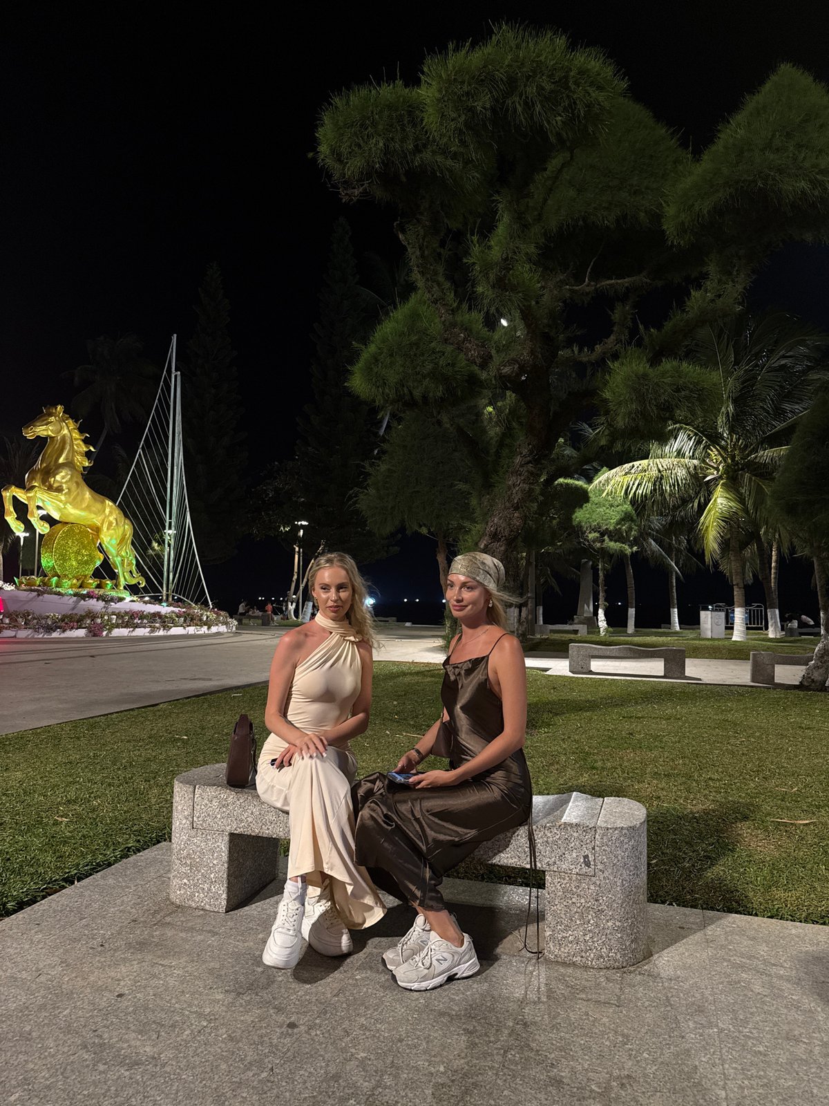 Two women photographed at night near Nha Trang Cathedral