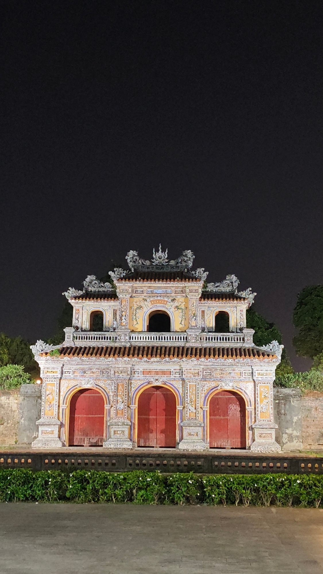 Ornate three-arched gate observed at night in Vietnam