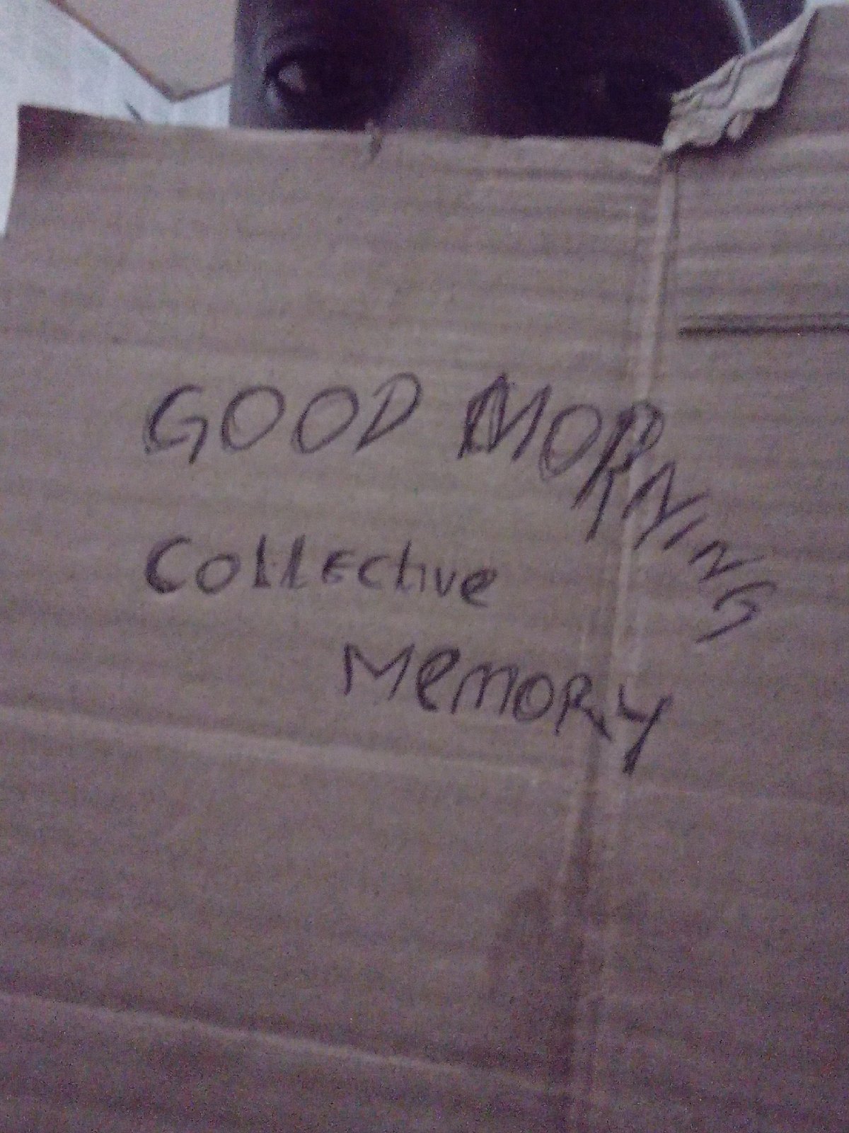 Person displays handwritten Collective Memory signs in Akwete Nigeria