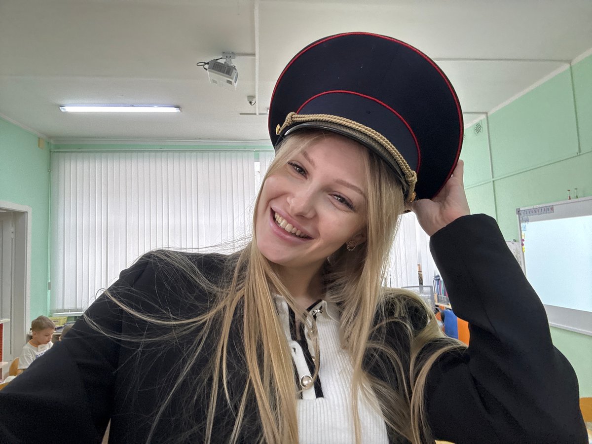 Woman in uniform cap visits classroom in Perm