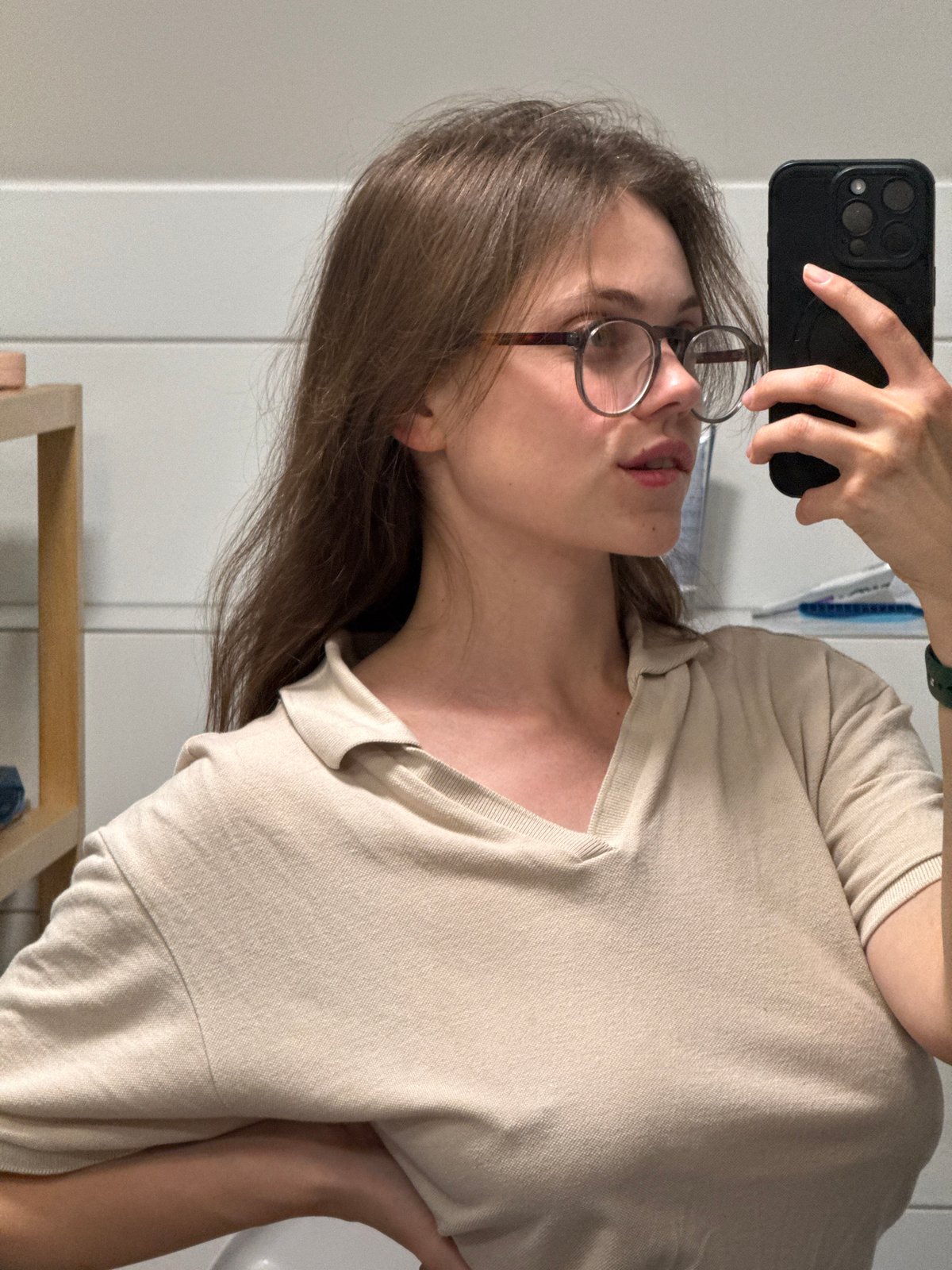 Woman takes bathroom mirror selfies in Vrchlabí, Czechia