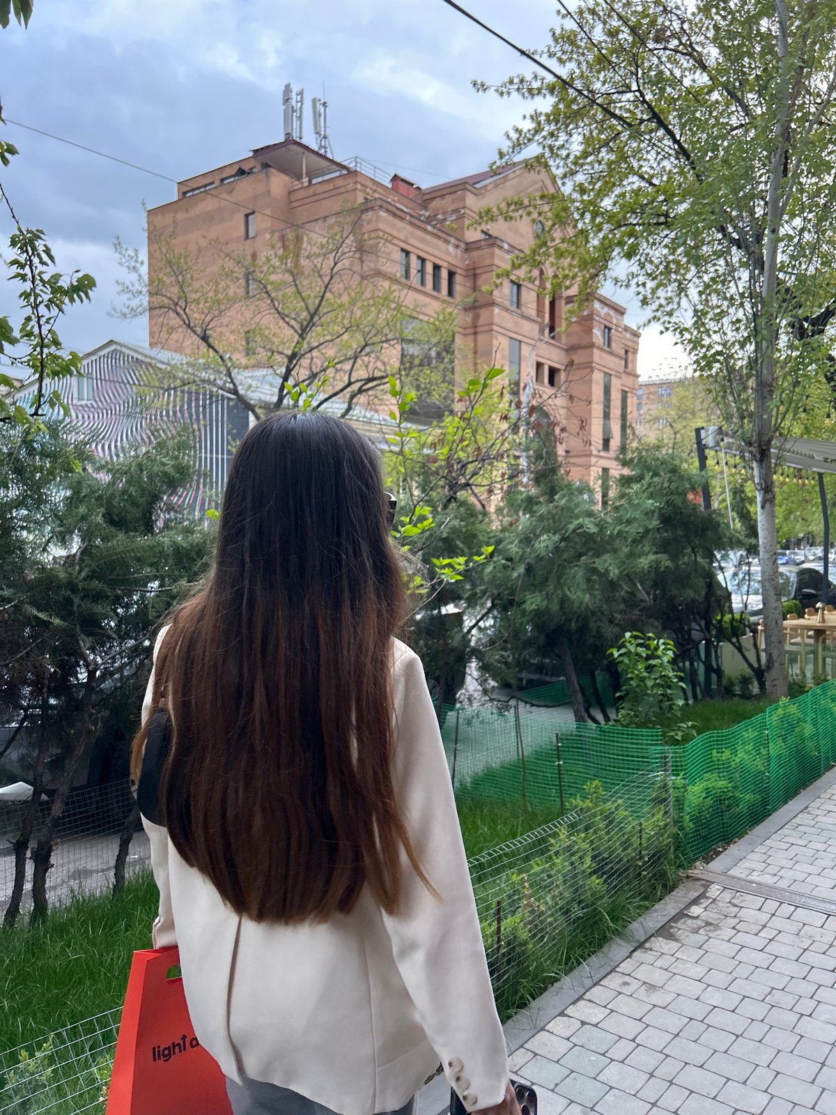 Pedestrians gather on Yerevan streets near Armenian cultural murals