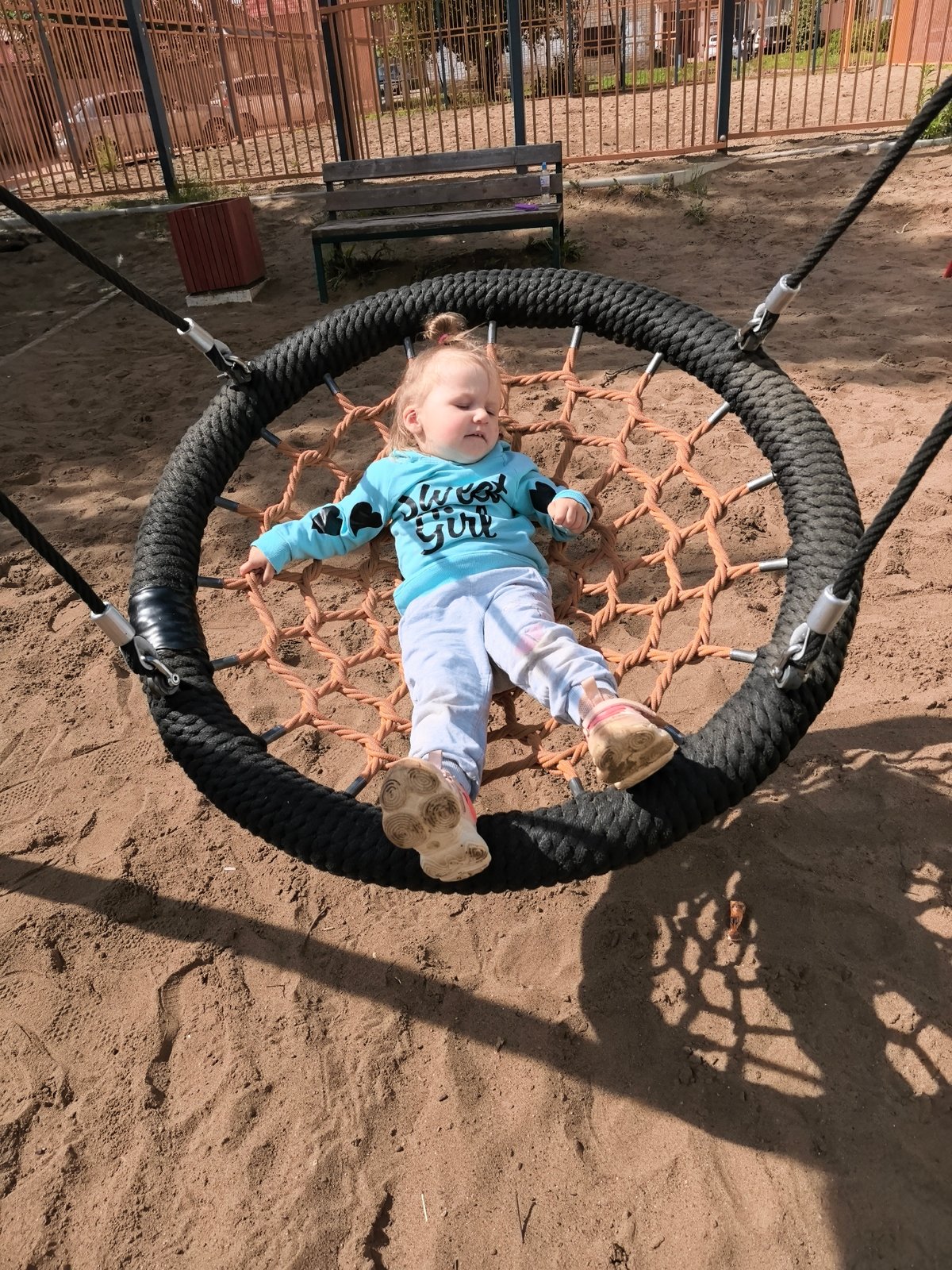 Child plays at outdoor playground during early morning hours