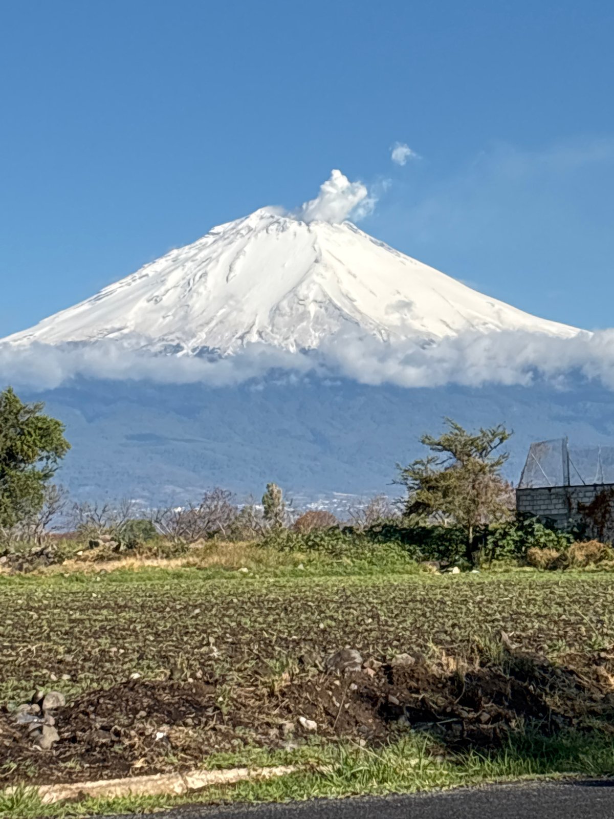 Snow-capped volcano emits steam plume in central Mexico