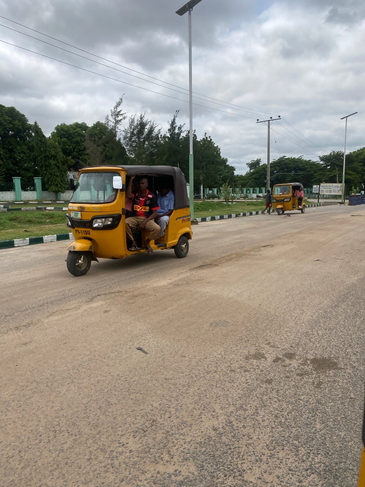 Street life and infrastructure along a main road in Kuson, Nigeria