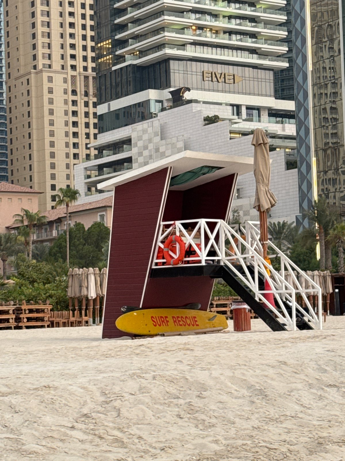 Dubai Marina beach on a hazy afternoon, Ain Dubai visible offshore