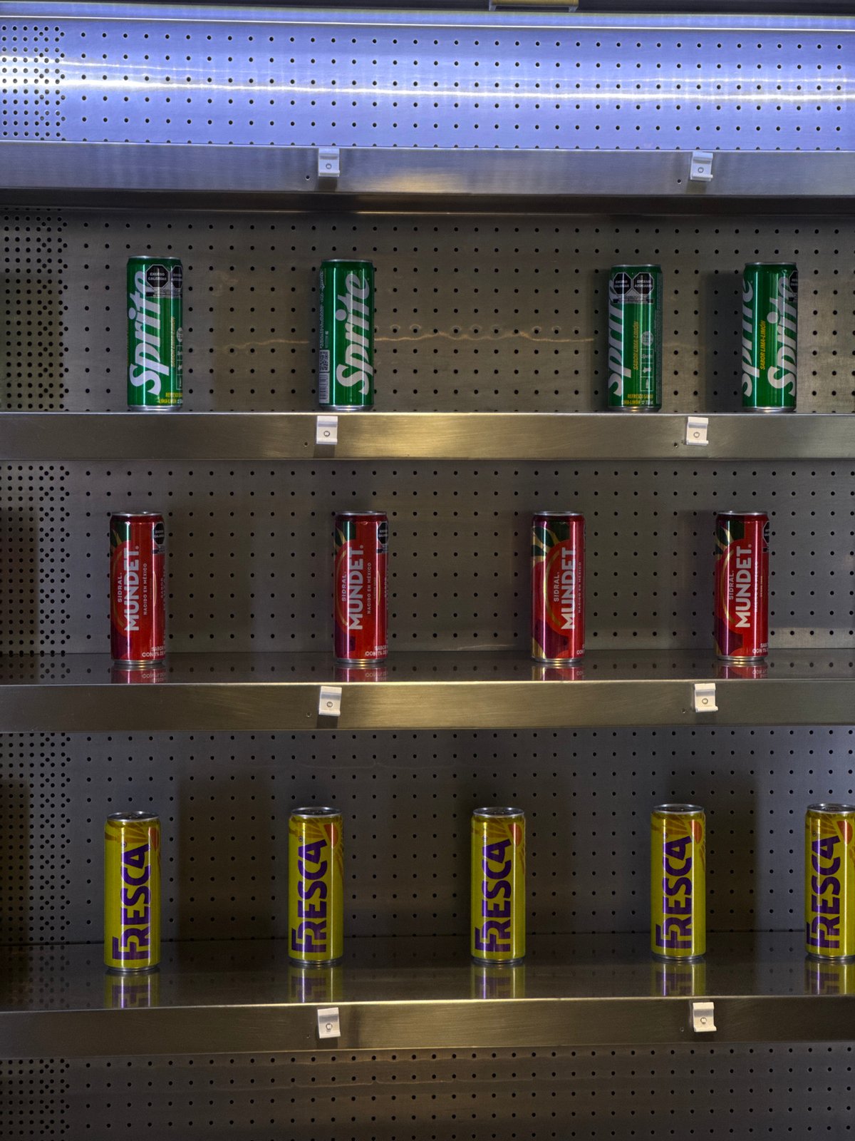 Soda vending machine stocked with beverages observed in Puebla