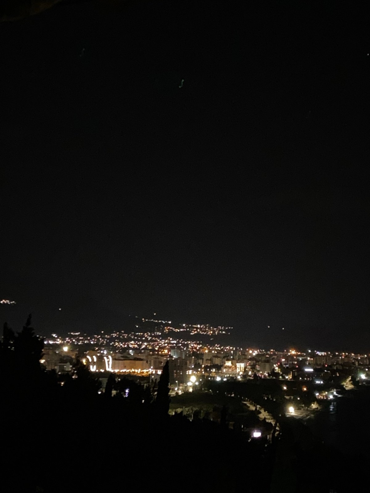 Nighttime cityscape view captured from elevated perspective in Šušanj