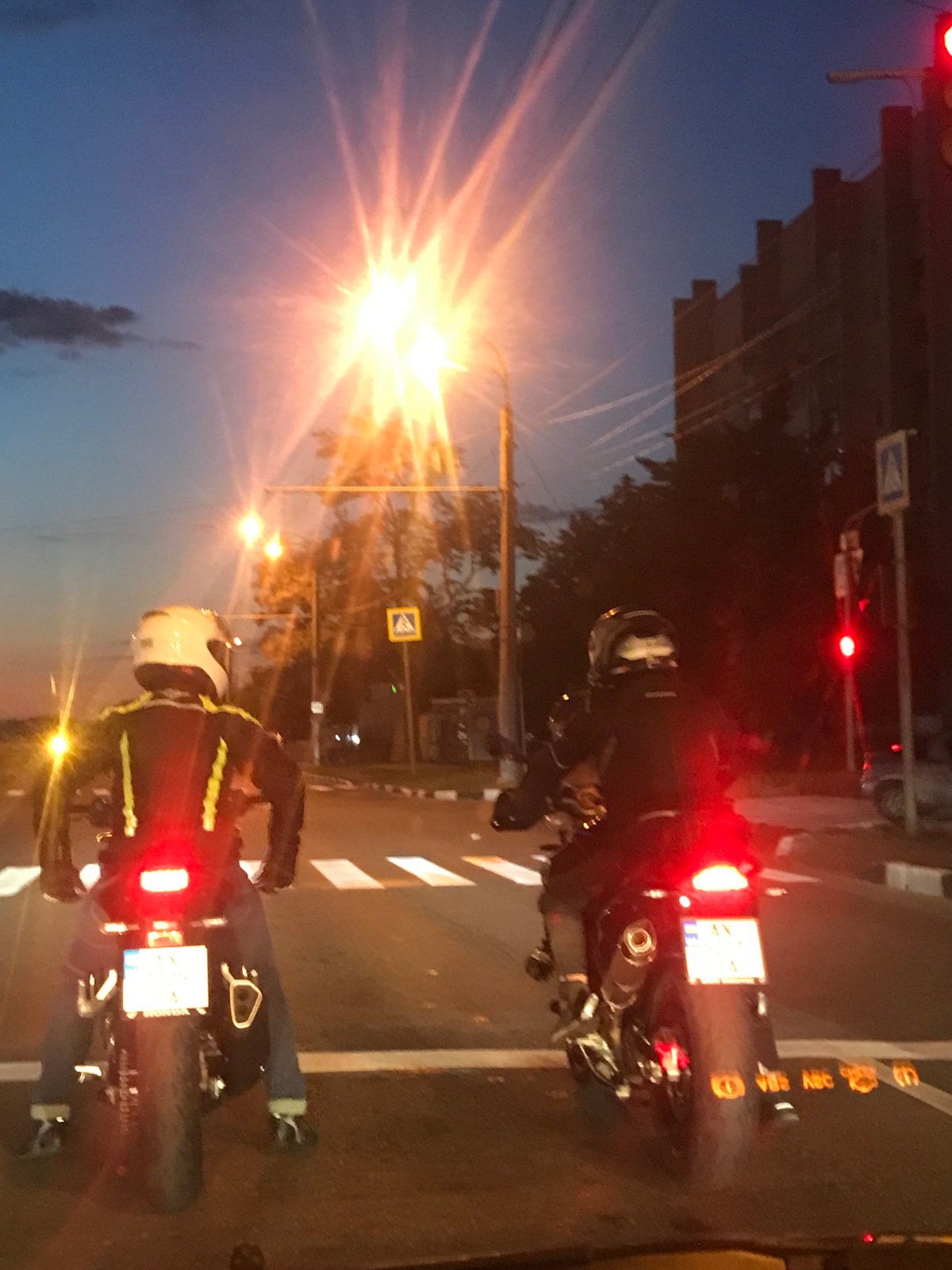 Motorcyclists wait at traffic light during Kharkiv evening rush