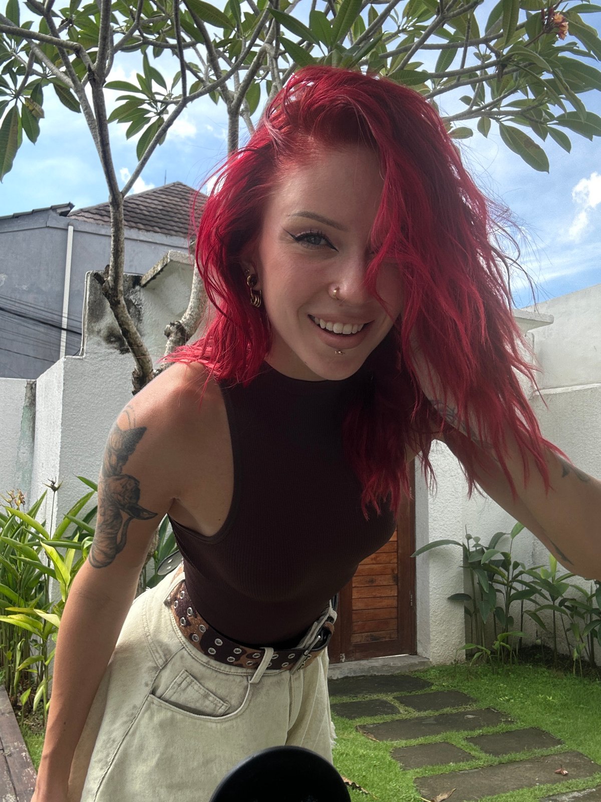 Red-haired woman photographed during outdoor session in North Kuta