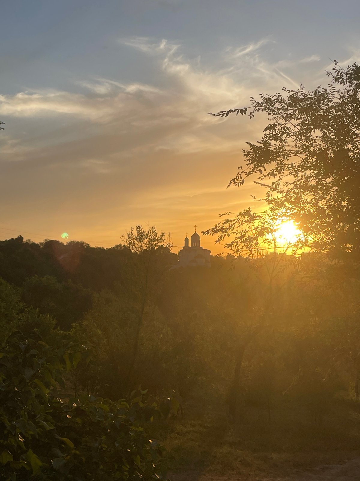 Almaty at golden hour: city, mountains, and sunset light