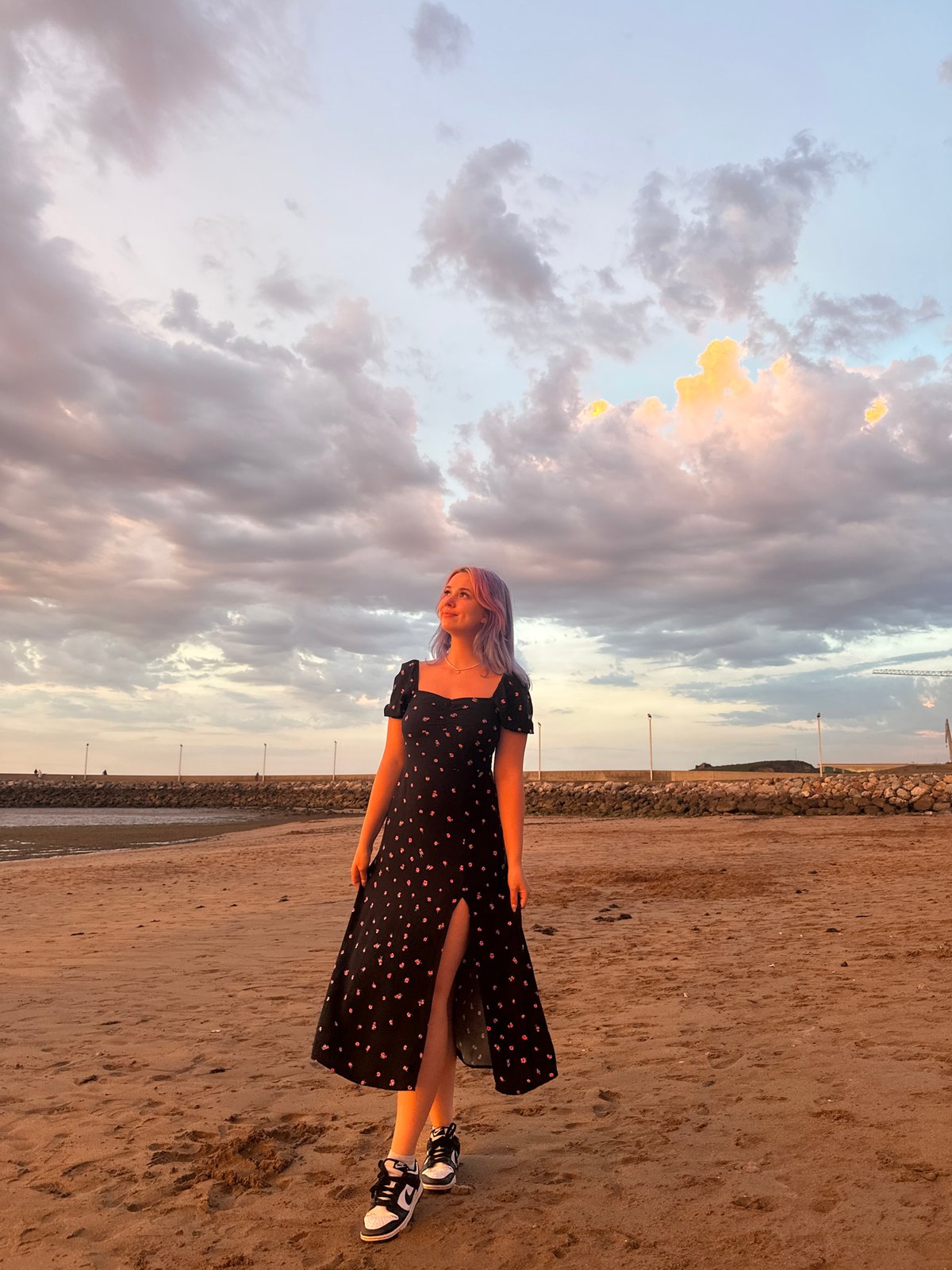 Dramatic sunset over Gijón beaches with selfies and coastal views