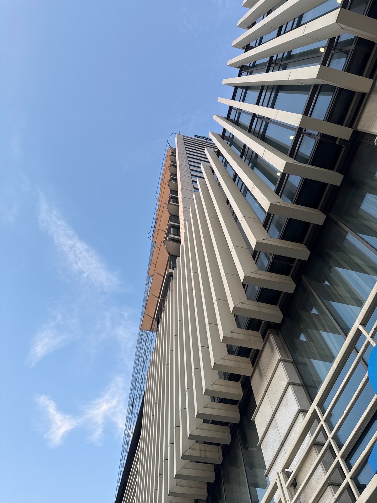 Modern glass building exterior, multiple angles, dusk and daytime