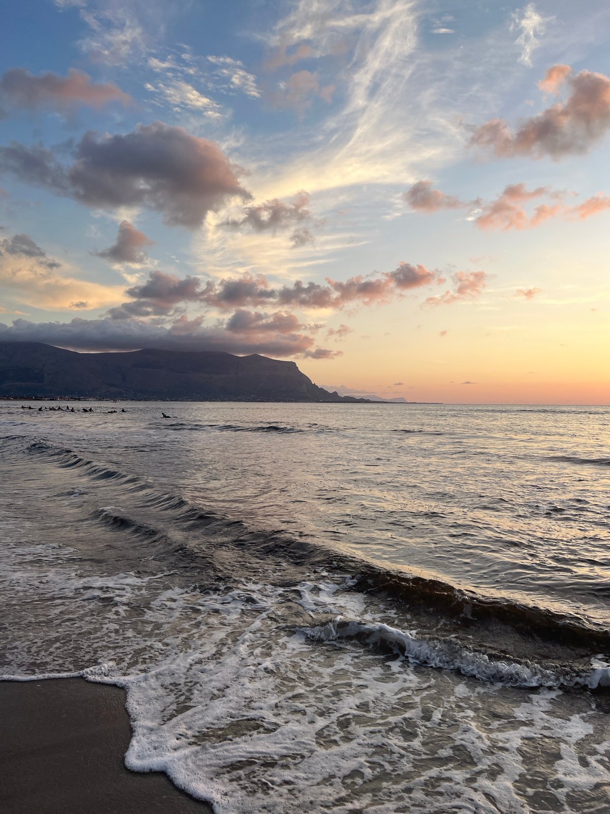 Mediterranean sunset with surfers at Isola delle Femmine