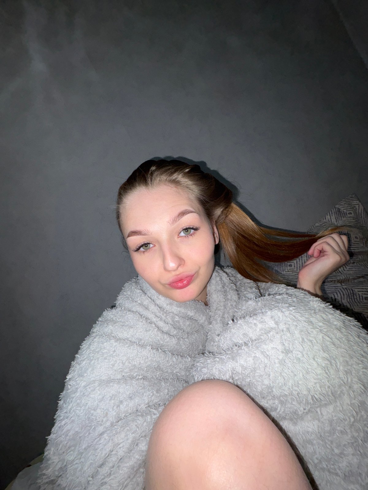 Woman photographed in bedroom setting in Chaikovsky, Russia