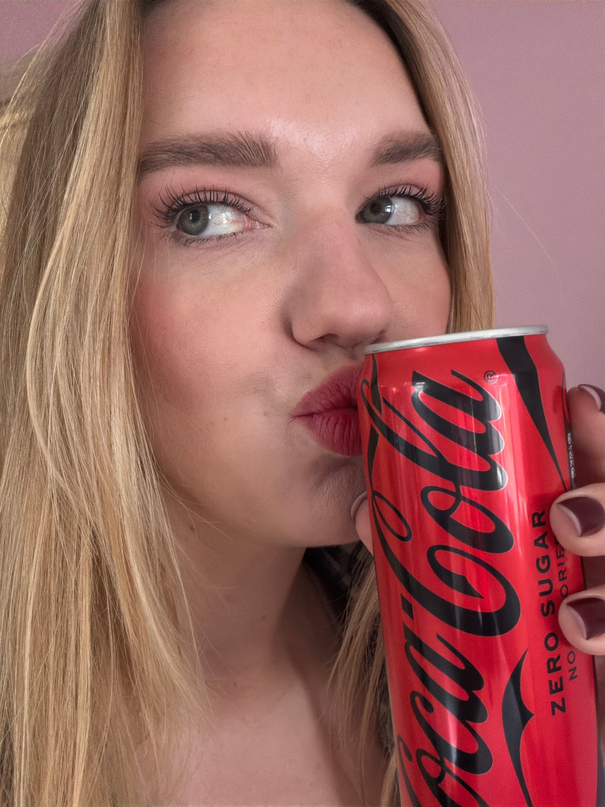 Woman enjoys Coke and marshmallow treats in Latvian home